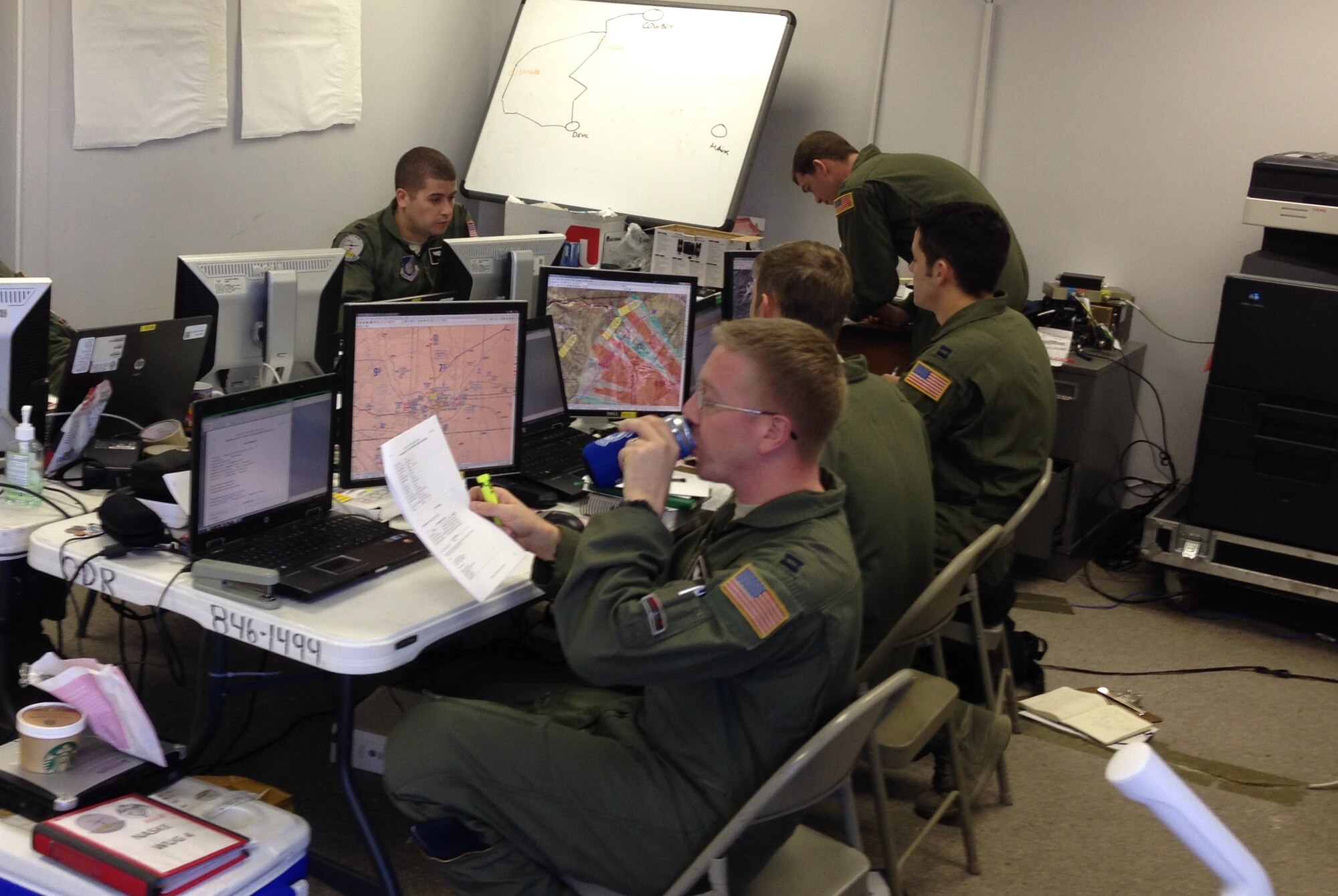 Students from the 57th Weapons Squadron spend 12-hour days preparing for a flying mission. About 40 members of the squadron were at Kirtland for an intense four-week Composite Mission Application phase training, part of the U.S. Air Force Weapons School curriculum.  Six students completed eight different flying missions, everything from mountainous low level operations to high pressure altitude operations, including an air drop from 24,000 feet.  . (Photo by Capt. Timothy Goodwillie)