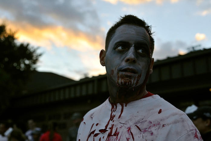 Tech. Sgt. Nolan Gibson, 437th Maintenance Squadron dock chief coordinator and “zombie,” looks for his next victim during the Joint Base Charleston Combined Federal Campaign Zombie Run Oct. 31, 2014, at JB Charleston, S.C. Gibson, along with 40 other volunteers, dressed up as zombies to participate in the charity event. (U.S. Air Force photo/Staff Sgt. Renae Pittman)
