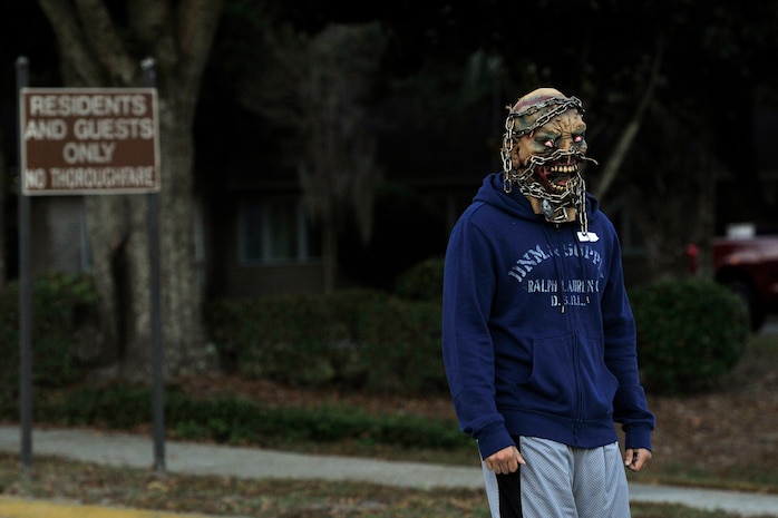 A volunteer dressed as a zombie waits for runners participating in the Joint Base Charleston Combined Federal Campaign Zombie Run Oct. 31, 2014, at JB Charleston, S.C. Forty volunteers and 250 runners participated in the 1.7 mile fund raising event. (U.S. Air Force photo/Staff Sgt. Renae Pittman)