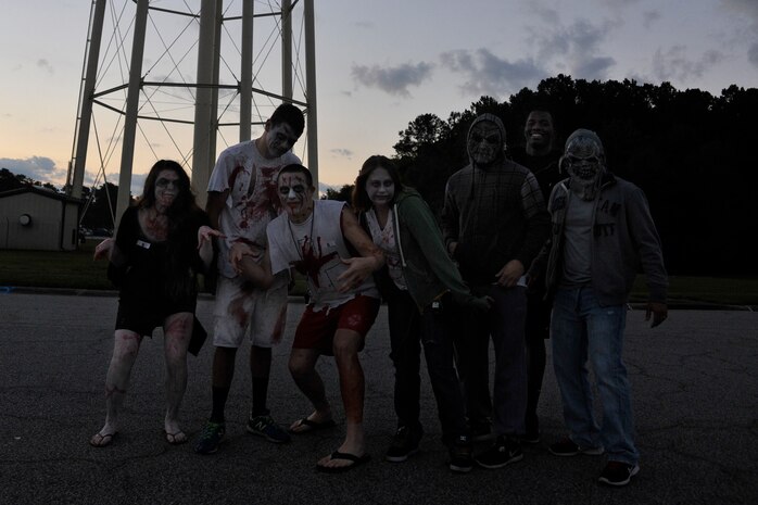A team of volunteers dressed as zombies pose for a photo prior to the start of the Joint Base Charleston Combined Federal Campaign Zombie Run Oct. 31, 2014, at JB Charleston, S.C. Approximately 40 volunteers chased the runners in three "contaminated areas" on the 1.7 mile course, (U.S. Air Force photo/Staff Sgt. Renae Pittman)