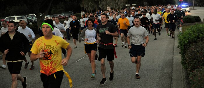 Runners prepare to meet the zombies during the Joint Base Charleston Combined Federal Campaign Zombie Run Oct. 31, 2014, at JB Charleston, S.C. The 1.7 mile run forced runners to dodge zombies in three "contaminated" areas in order to "survive." (U.S. Air Force photo/Staff Sgt. Renae Pittman)