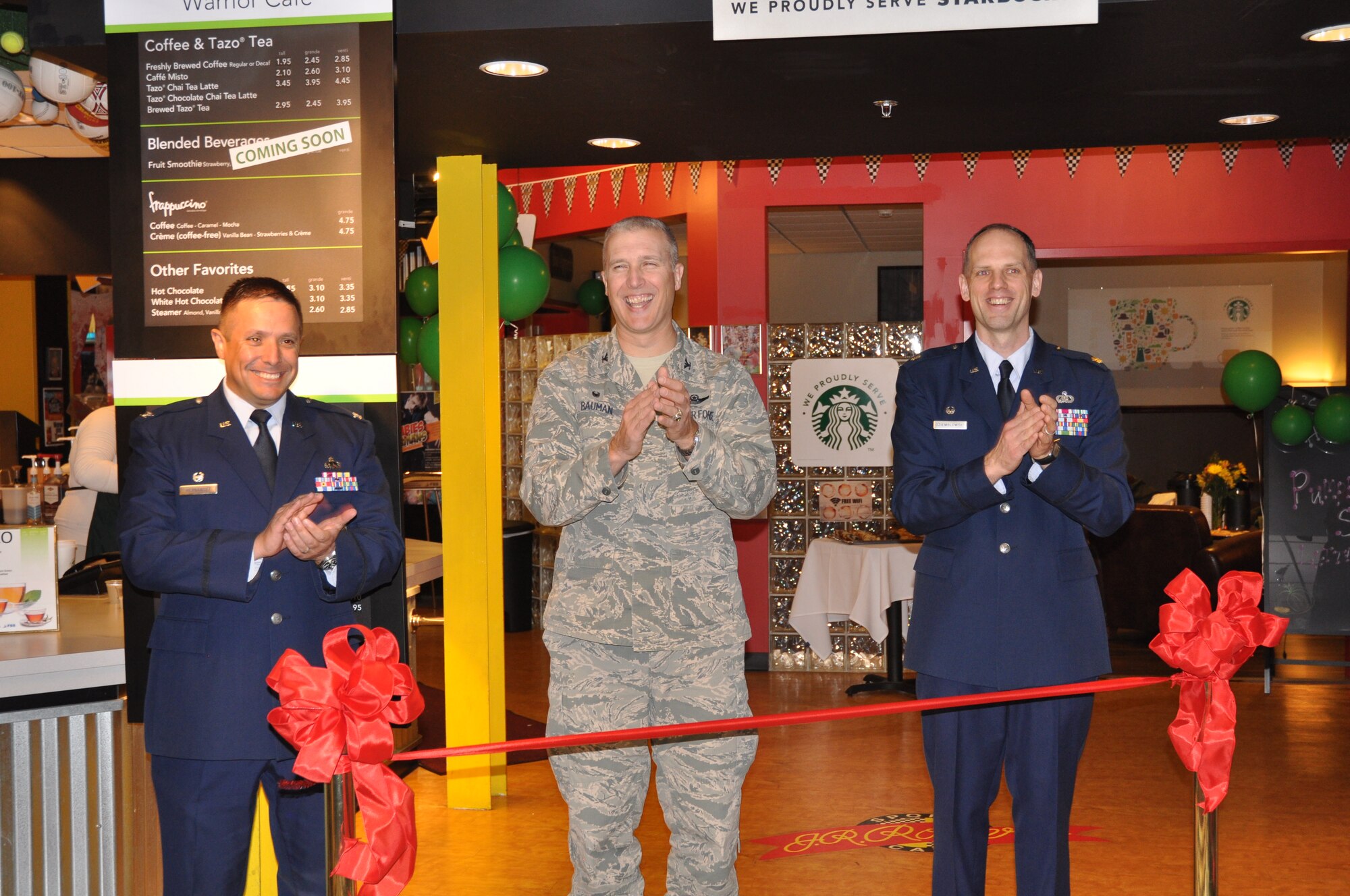 From left, Col. Anthony Hernandez, 319th Mission Support Group commander, Col. Paul Bauman, 319th Air Base Wing commander, and Maj. Thomas Oziemblowsky, 319th Force Support Squadron commander, prepare to cut the ribbon at the grand opening of the base café Oct. 27, 2014, at J.R. Rockers on Grand Forks Air Force Base, N.D. By popular request, J.R. Rockers now serves name-brand coffee beverages. Renovations to J.R. Rockers also included redesigning the game room into a sit-down café. (Courtesy photo)
