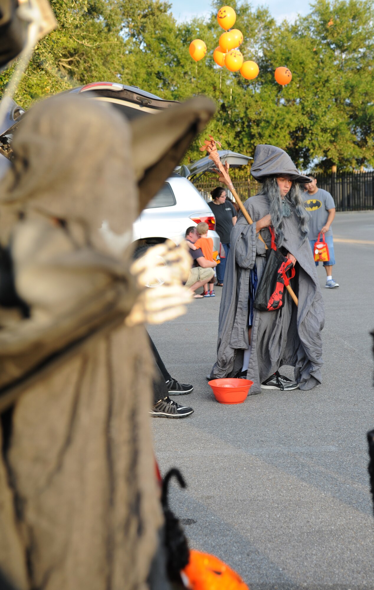 The son of Lt. Col. James Coughlin, 85th Engineering Installation Squadron commander, walks around the parking lot collecting candy from the trunks of vehicles during the 2nd Annual 85th EIS Trunk-Or-Treat Oct. 29, 2014, at Maltby Hall, Keesler Air Force Base, Miss.  The event included a costume contest, trunk-or-treating and pumpkin painting.  (U.S. Air Force photo by Kemberly Groue)