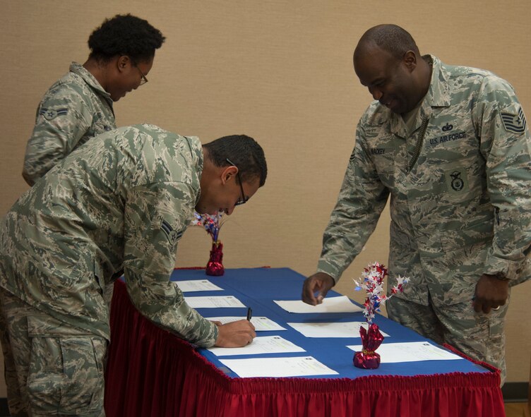 U.S. Air Force Tech. Sgt. Phillip Mackey, AFSA Chapter 460 programs trustee, encourages AFSA members Airmen 1st Class Aneke Miller and Grey Jackson to volunteer for community service events at the chapter’s general membership meeting Aug. 14, 2014 at Moody Air Force Base, Ga. AFSA Chapter 460 supplied Valdosta and surrounding areas with 6,000 volunteer hours in 2013. (U.S. Air Force photo by 2nd Lt. Brianca Williams/Released)