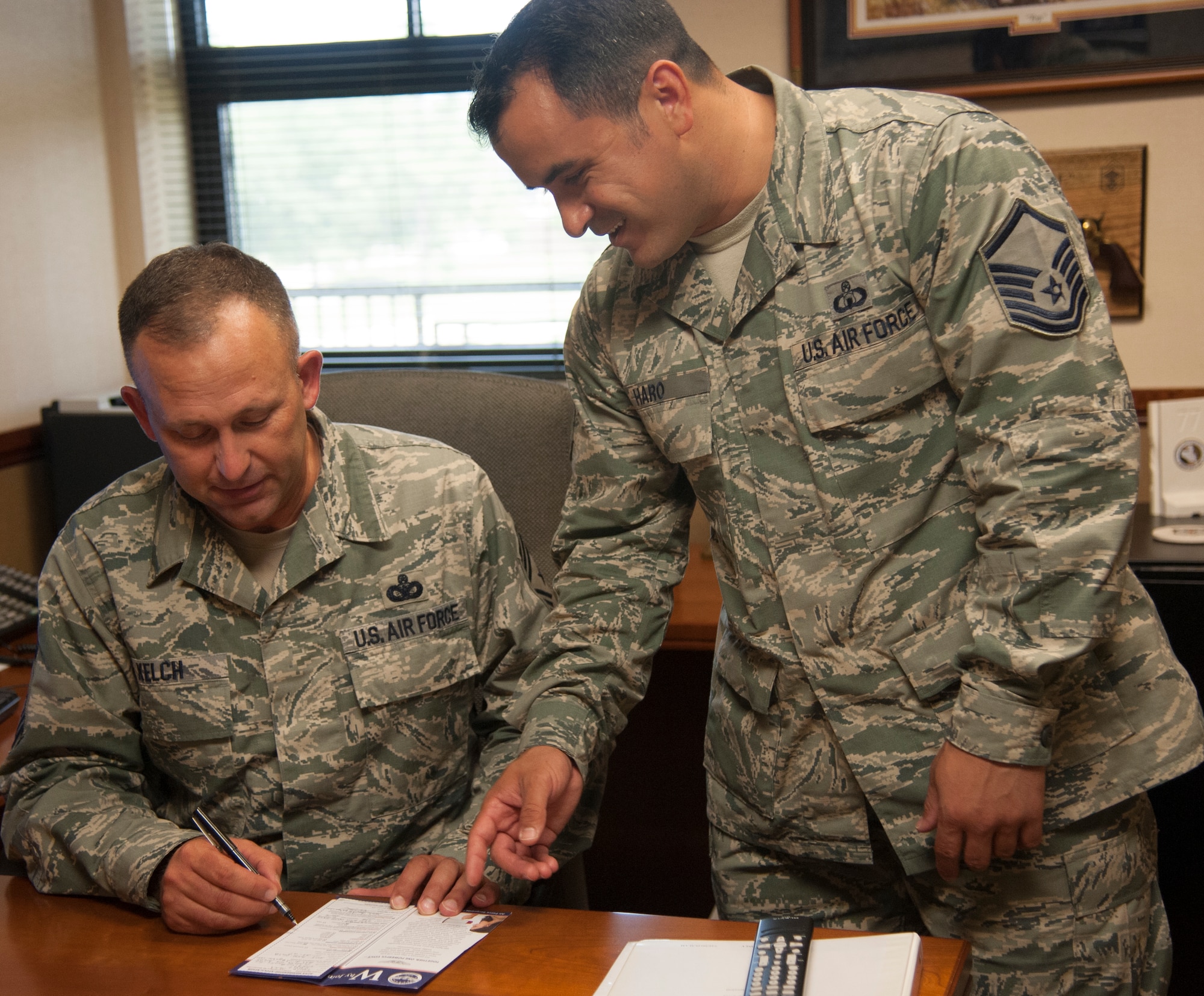 U.S. Air Force Chief Master Sgt. David Kelch, 23d Wing command chief, signs up for Air Force Sergeants Association (AFSA) Chapter 460 membership with the assistance of Master Sgt. Steven Haro, Chapter 460 president, July 30, 2014 at Moody Air Force Base, Ga. The chapter had only 300 active members in 2012, but membership peaked to more than 1,000 members as of September 2014. (U.S. Air Force photo by 2nd Lt. Brianca Williams/Released)