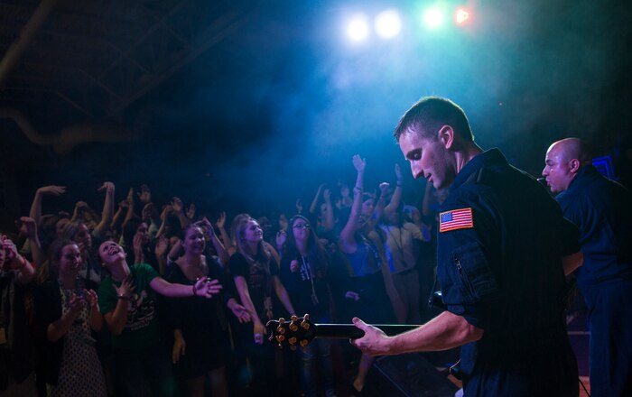 Staff Sgt. Aaron Weibe, a guitarist with the U.S. Air Force Heritage of America Band Full Spectrum, performs in front of hundreds of West Ashley high school students Oct. 29, 2014, at West Ashley High School in Charleston, S.C. Full Spectrum, a high energy band that features a horn section, is one of the newest ensembles in the Air Force’s Heritage of America Band. This group of dynamic musicians performs a 'full spectrum' of music - ranging from Pop, Hip Hop, Funk, R&B, Latin and Classic Rock.  (U.S. Air Force photo/Airman 1st Class Clayton Cupit)
