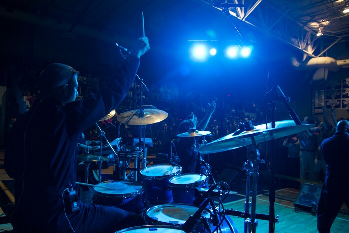 Staff Sgt. John Sayre, a drummer with the U.S. Air Force Heritage of America Band Full Spectrum, performs in front of hundreds of West Ashley high school students Oct. 29, 2014, at West Ashley High School in Charleston, S.C. Featuring members with vast musical knowledge and extensive performance resumes, Full Spectrum was created for an Air Force Heritage of America Band deployment to Southwest Asia in May 2013. After months performing in forward operating environments for U.S. and coalition troops and building International partnerships, they are now bringing their deployed experiences to audiences up and down the East Coast from South Carolina to Maine. (U.S. Air Force photo/Airman 1st Class Clayton Cupit)