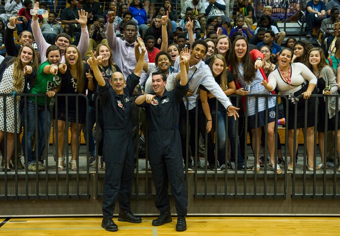 Master Sgt. Tyler Selden, a saxophonist for the U.S. Air Force Heritage of America Band Full Spectrum, and Staff Sgt. Jordan Kimble, the band’s bassist, pose for a photo with West Ashley High School students Oct. 29, 2014, in Charleston, S.C. Featuring members with vast musical knowledge and extensive performance resumes, Full Spectrum was created for an Air Force Heritage of America Band deployment to Southwest Asia in May 2013. After months performing in forward operating environments for U.S. and coalition troops and building International partnerships, they are now bringing their deployed experiences to audiences up and down the East Coast from South Carolina to Maine. (U.S. Air Force photo/Airman 1st Class Clayton Cupit)