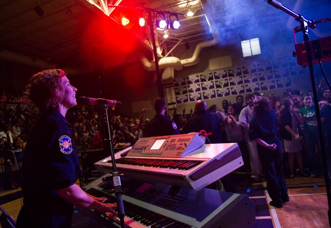 Senior Airman Michelle Hooper, a pianist with the U.S. Air Force Heritage of America Band Full Spectrum, sings along with other band members Oct. 29, 2014, at West Ashley High School in Charleston, S.C. Full Spectrum, a high energy band that features a horn section, is one of the newest ensembles in the Air Force’s Heritage of America Band. This group of dynamic musicians  performs a 'full spectrum' of music - ranging from Pop, Hip Hop, Funk, R&B, Latin and Classic Rock. (U.S. Air Force photo/Airman 1st Class Clayton Cupit)