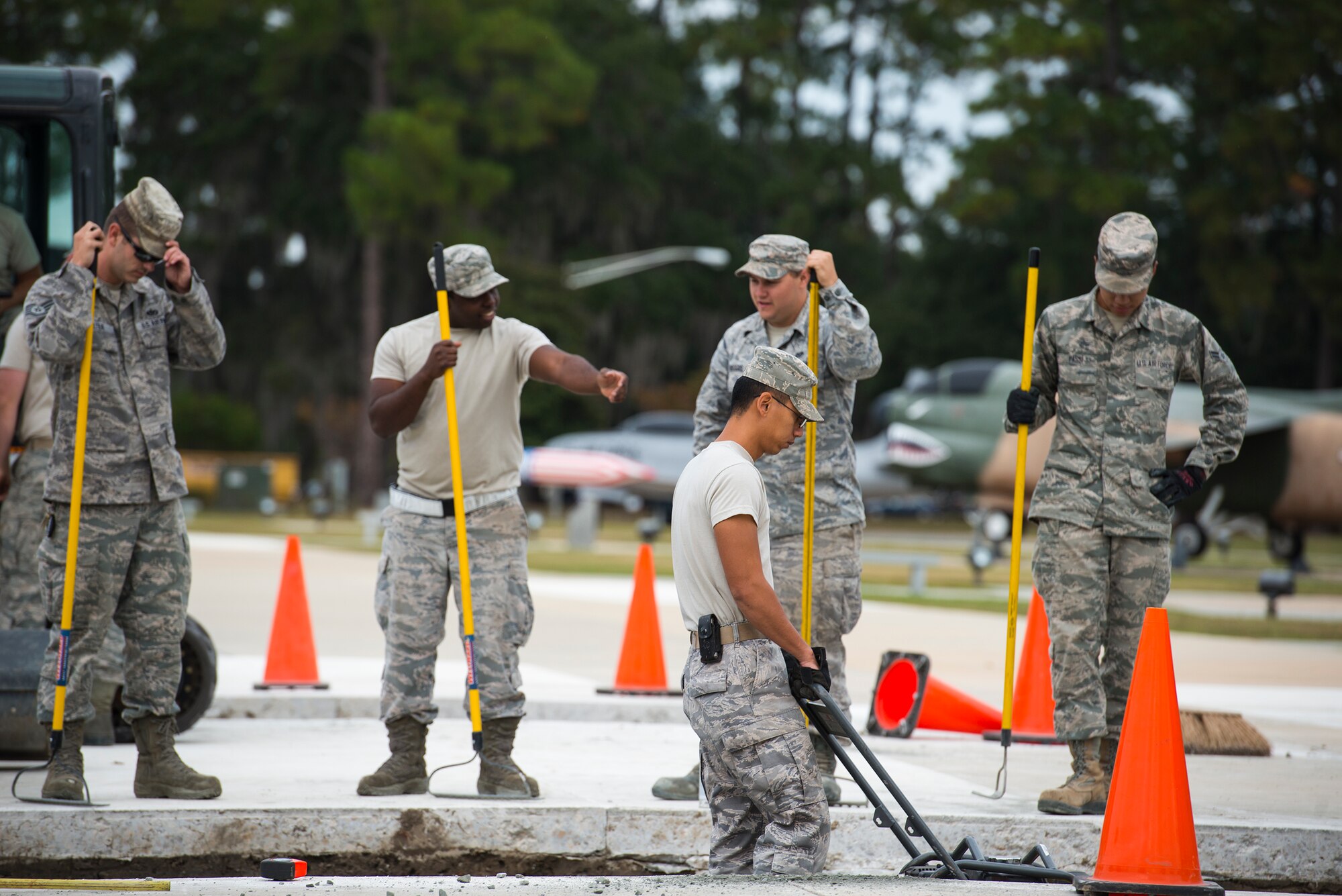 Airmen from the 23d Civil Engineer Squadron flatten a gravel foundation Oct. 30, 2014, at Moody Air Force Base, Ga. The Airmen added two, six-inch thick slabs of concrete to the President George W. Bush Air Park to accommodate the weight of an HC-130P Combat King. (U.S. Air Force photo by Airman 1st Class Ryan Callaghan/Released)