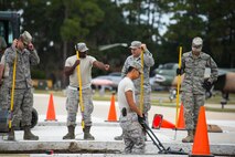 Airmen from the 23d Civil Engineer Squadron flatten a gravel foundation Oct. 30, 2014, at Moody Air Force Base, Ga. The Airmen added two, six-inch thick slabs of concrete to the President George W. Bush Air Park to accommodate the weight of an HC-130P Combat King. (U.S. Air Force photo by Airman 1st Class Ryan Callaghan/Released)