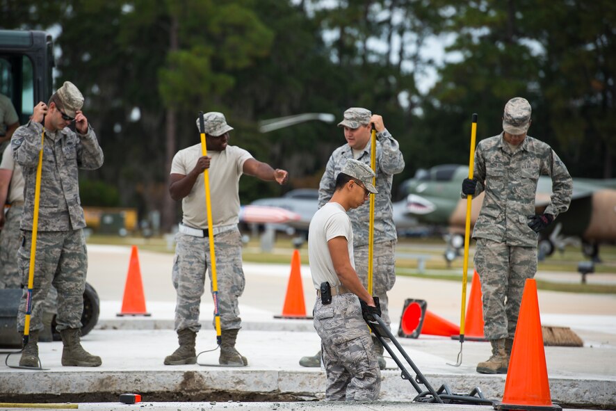 Airmen from the 23d Civil Engineer Squadron flatten a gravel foundation Oct. 30, 2014, at Moody Air Force Base, Ga. The Airmen added two, six-inch thick slabs of concrete to the President George W. Bush Air Park to accommodate the weight of an HC-130P Combat King. (U.S. Air Force photo by Airman 1st Class Ryan Callaghan/Released)