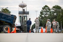 Airmen from the 23d Civil Engineer Squadron pour gravel into a hole Oct. 30, 2014, at Moody Air Force Base, Ga. Prior to pouring the new concrete, the Airmen first had to lay down a foundation to ensure the pavement would settle correctly. (U.S. Air Force photo by Airman 1st Class Ryan Callaghan/Released)