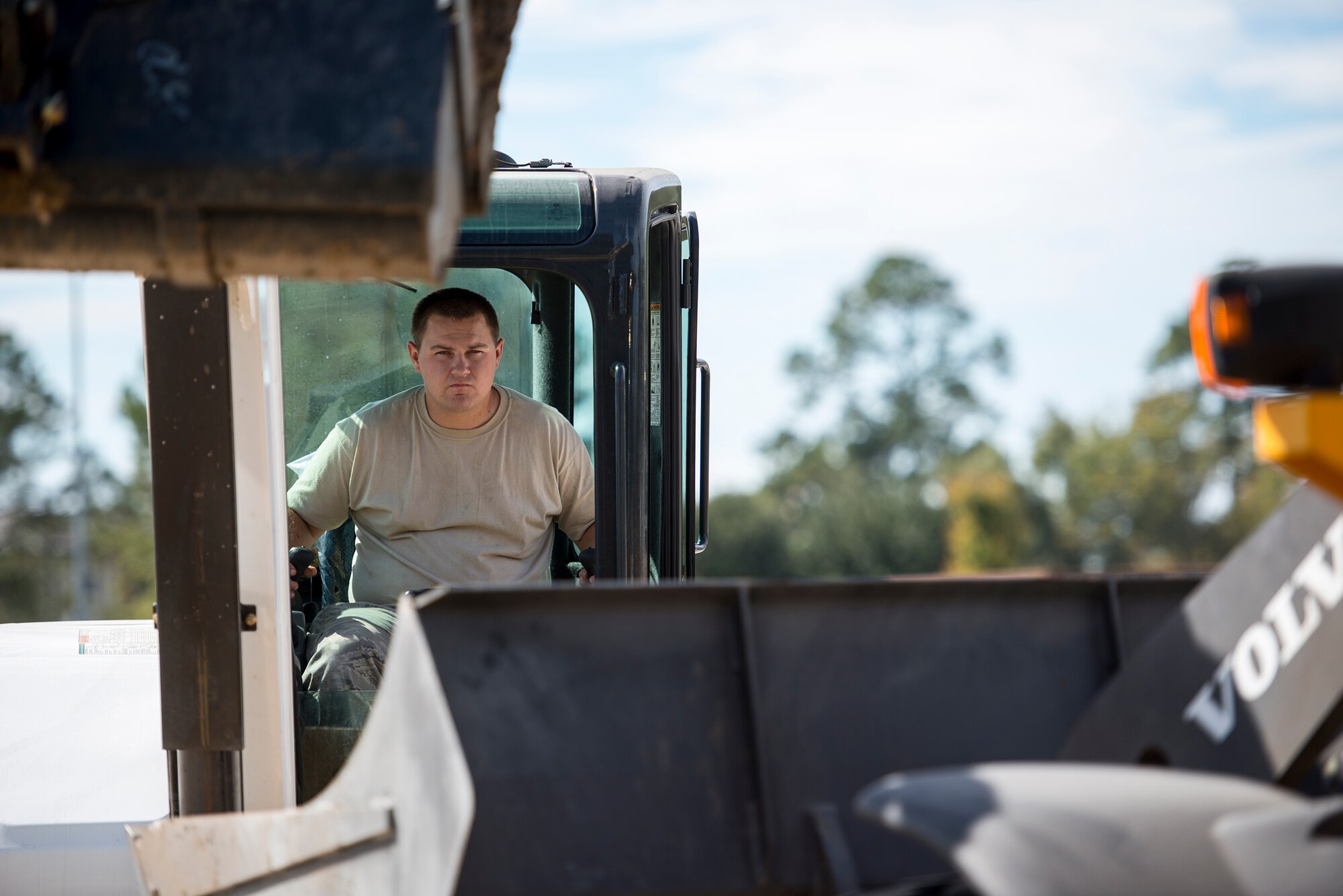 U.S. Air Force Senior Airman Chason Rogers, 23d Civil Engineer Squadron heavy equipment, pavement and construction journeyman, operates an excavator Oct. 29, 2014, at Moody Air Force Base, Ga. As a pavement and constructions journeyman, Rogers is responsible for operating and maintaining heavy construction equipment to construct, maintain and inspect concrete and asphalt structures. (U.S. Air Force photo by Airman 1st Class Ryan Callaghan/Released)