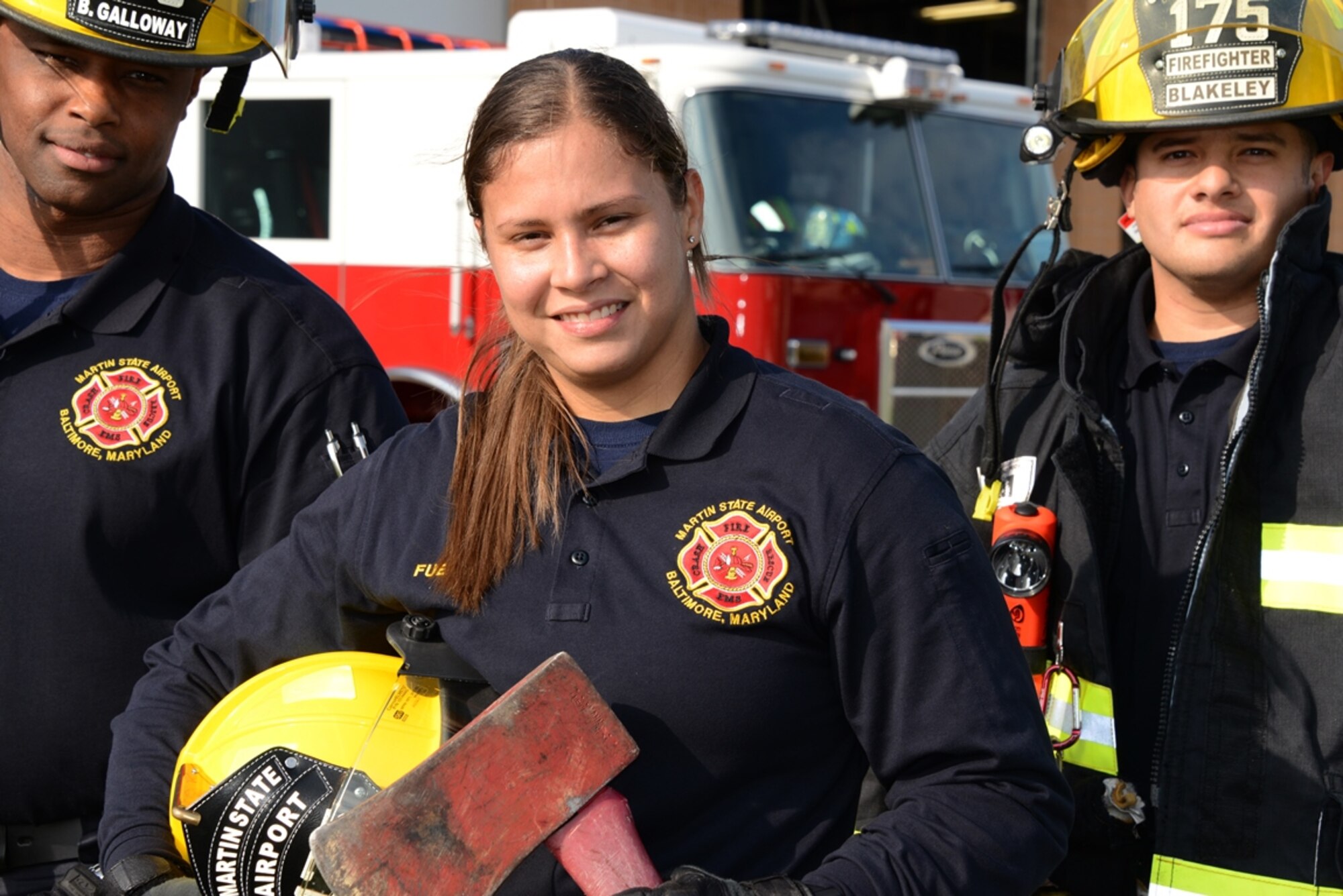 Bill Galloway, left, Senior Airman Sheila M. Fuentes and Staff Sgt. William Blakeley are full-time firefighter at Warfield Air National Guard Base; Fuentes left her unit and home in Puerto Rico to pursue a career in firefighting in the Maryland Air National Guard. (U.S. Air National Guard photo by Senior Master Sgt. Ed Bard/RELEASED))