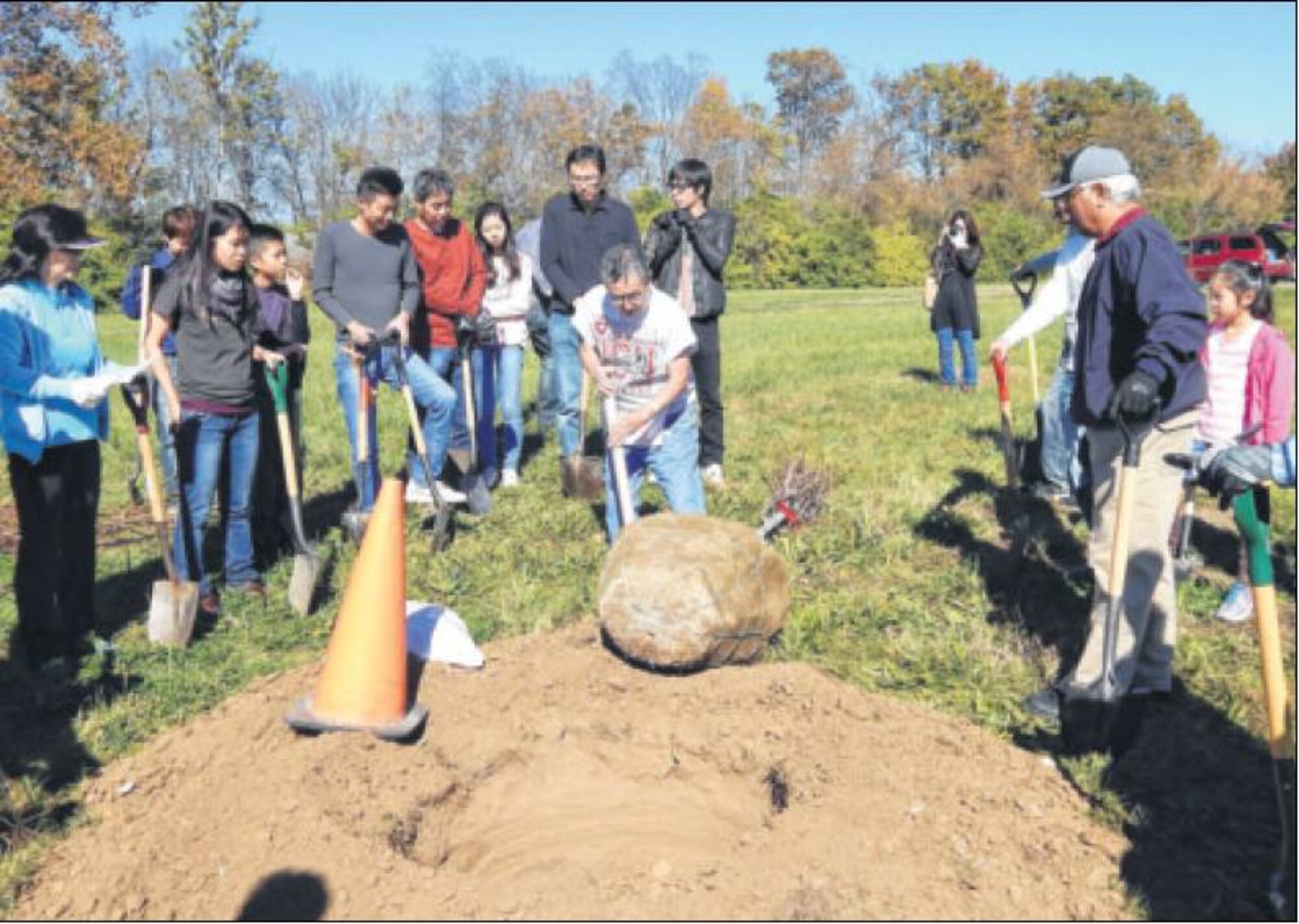 Alex Hara, organizer of the Operation 1000 Cherry Tree Project, explains to volunteers how to plant the trees and how the trees should look when they are in place. (Photos by Cindy Holbrook)