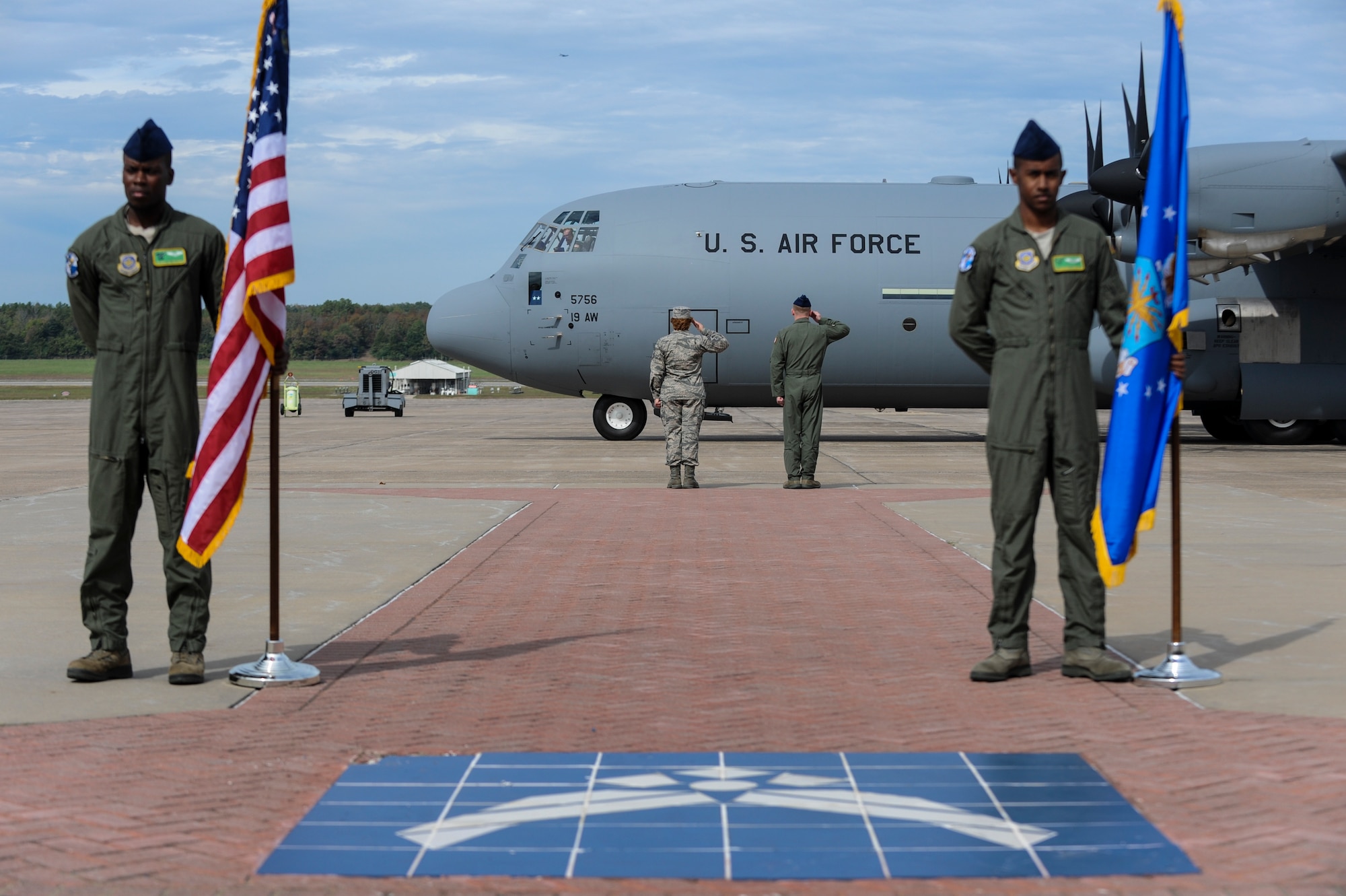 Col. Patrick Rhatigan, 19th Airlift Wing commander, and Chief Master Sgt. Rhonda Buening, 19th AW command chief, render a salute as Major General Mike Stough, Headquarters Air Mobility Command director of strategic plans, requirements and programs, arrives at Little Rock Air Force Base, Ark., Oct. 23, 2014. The C-130J is the newest and most sophisticated of the C-130 models, slowly superseding the old, but always reliable C-130H.  (U.S. Air Force photo by Airman 1st Class Cliffton Dolezal)