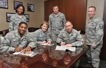 Chief Master Sgt. Phillip Easton, 341st Missile Wing command chief, Col. Marné Deranger, 341 MW vice commander, and Col. Tom Wilcox, 341 MW commander, complete their Combined Federal Campaign pledge forms Oct. 29. Tech. Sgt. Cinnamon Calloway-Fuller, 819th RED HORSE Squadron (left), and Master Sgt. Jim Ulrich, 12th Missile Squadron (center), base CFC representatives, and Master Sgt. Thomas Moore, 341st MW safety office, Wing Staff Agency CFC representative, stand ready to accept their forms. The campaign ends Nov. 18 and Malmstrom Air Force Base’s goal this year is $100,000. The CFC is the most inclusive workplace giving campaign in the world with the number of participating charities estimated at over 20,000 nonprofit charitable organizations worldwide, according to http://www.opm.gov/combined-federal-campaign/ . (U.S. Air Force photo/John Turner)