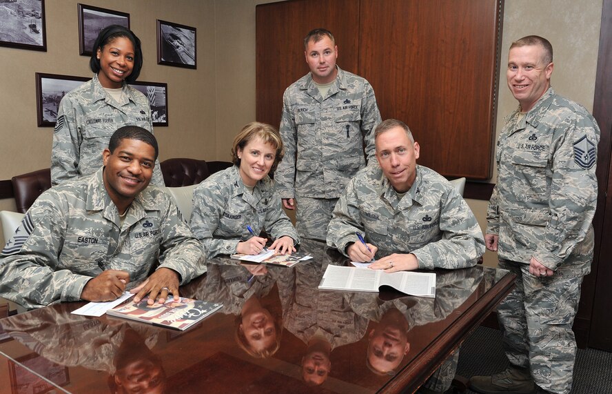 Chief Master Sgt. Phillip Easton, 341st Missile Wing command chief, Col. Marné Deranger, 341 MW vice commander, and Col. Tom Wilcox, 341 MW commander, complete their Combined Federal Campaign pledge forms Oct. 29. Tech. Sgt. Cinnamon Calloway-Fuller, 819th RED HORSE Squadron (left), and Master Sgt. Jim Ulrich, 12th Missile Squadron (center), base CFC representatives, and Master Sgt. Thomas Moore, 341st MW safety office, Wing Staff Agency CFC representative, stand ready to accept their forms. The campaign ends Nov. 18 and Malmstrom Air Force Base’s goal this year is $100,000. The CFC is the most inclusive workplace giving campaign in the world with the number of participating charities estimated at over 20,000 nonprofit charitable organizations worldwide, according to http://www.opm.gov/combined-federal-campaign/ . (U.S. Air Force photo/John Turner)