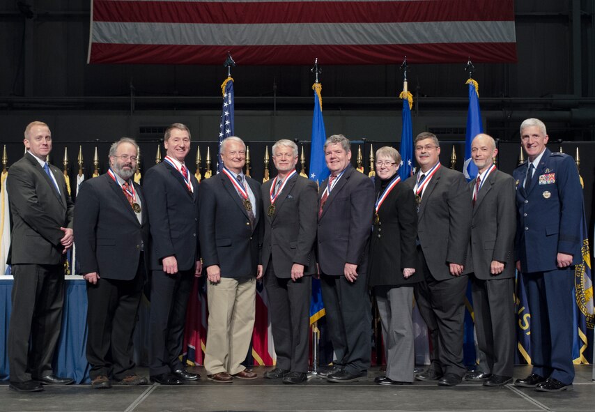 Dr. Morley Stone (far left), Air Force Research Laboratory chief technology officer and Maj. Gen. Tom Masiello, AFRL commander, honor AFRL's 2014 Fellows inductees Oct. 30 at the National Museum of the U.S. Air Force.  The Fellows award is the Laboratory's highest honor and selection represents the top 0.2 percent of all professional technical personnel. Each Fellow receives a two-year research grant of $150,000 per year.  The 2014 Fellows are Mr. Ralph Kohler, Dr. Paul Antonik, Mr. Paul Kervin, Dr. Alan Ohrt, Dr. Kevin Priddy, Ms. Stephanie Miller, Dr. Charles Cross, and Dr. Gregory Vansuch.  (U.S. Air Force photo/Mikee Huber)