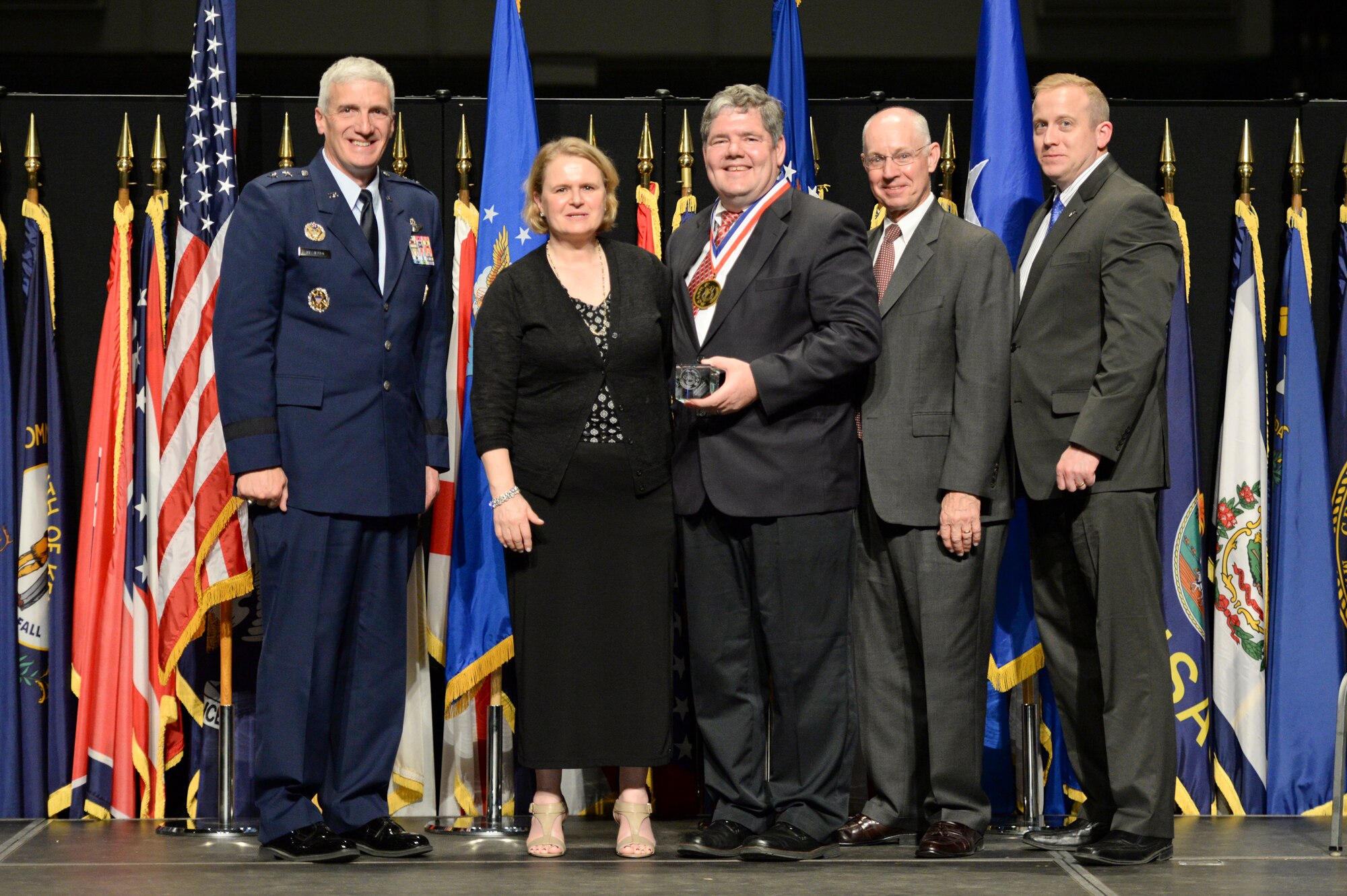 Dr. Kevin Priddy, chief, Avionics Engineering Division, Air Force Life Cycle Management Center, and his wife Wendy, are honored during the 2014 Air Force Research Laboratory Fellows and Early Career Awards Banquet Oct. 30 at the National Museum of the U.S. Air Force. Joining them are Maj. Gen Tom Masiello, AFRL commander, retired Maj. Gen. Dick Paul, AFRL's first commander, and Dr. Morley Stone, AFRL chief technology officer.  (U.S. Air Force photo/Wesley Farnsworth)