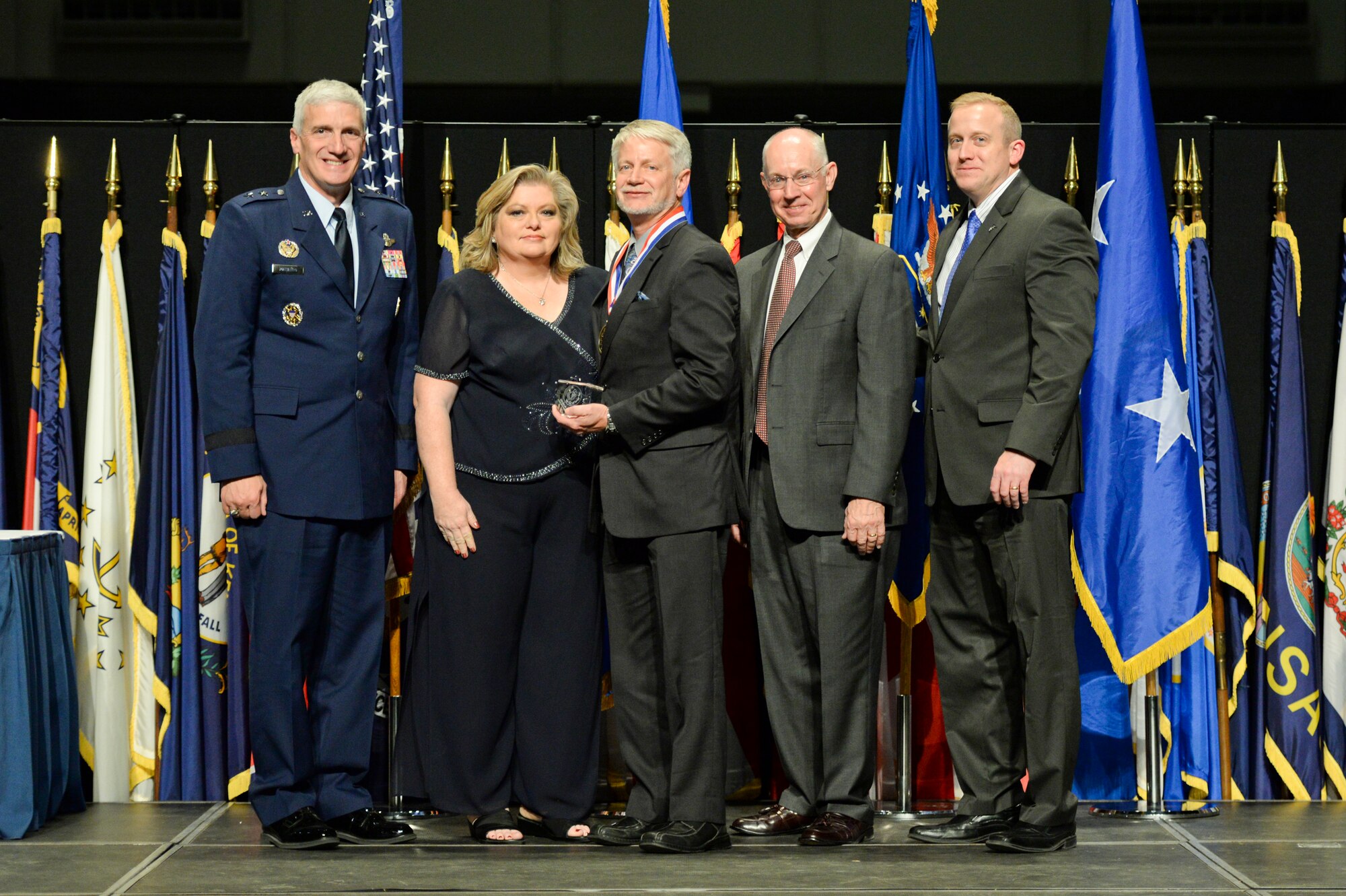 Dr. Alan Ohrt, principal mechanical engineer, Air Force Research Laboratory Munitions Directorate, and his wife Emma, are honored during the 2014 AFRL Fellows and Early Career Awards Banquet Oct. 30 at the National Museum of the U.S. Air Force.  Joining them are Maj. Gen. Tom Masiello, AFRL commander, retired Maj. Gen. Dick Paul, AFRL's first commander, and Dr. Morley Stone, AFRL chief technology officer.  (U.S. Air Force photo/Wesley Farnsworth)
