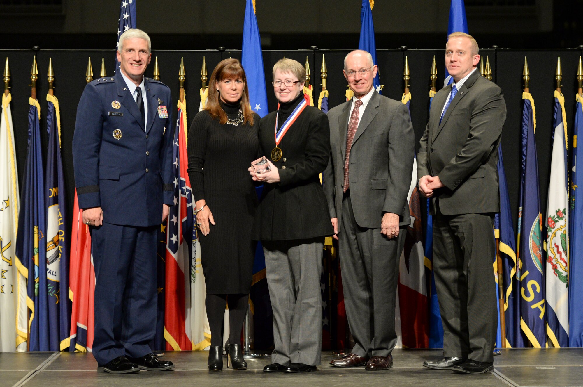 Ms. Stephanie Miller, chief, Radio Frequency Bioeffects Branch, 711th Human Performance Wing, and her sister Natalie, are honored during the 2014 Air Force Research Laboratory Fellows and Early Career Awards Banquet Oct. 30 at the National Museum of the U.S. Air Force.  Joining them are Maj. Gen. Tom Masiello, AFRL commander, retired Maj. Gen. Dick Paul, AFRL's first commander, and Dr. Morley Stone, AFRL chief technology officer. (U.S. Air Force photo/Wesley Farnsworth)