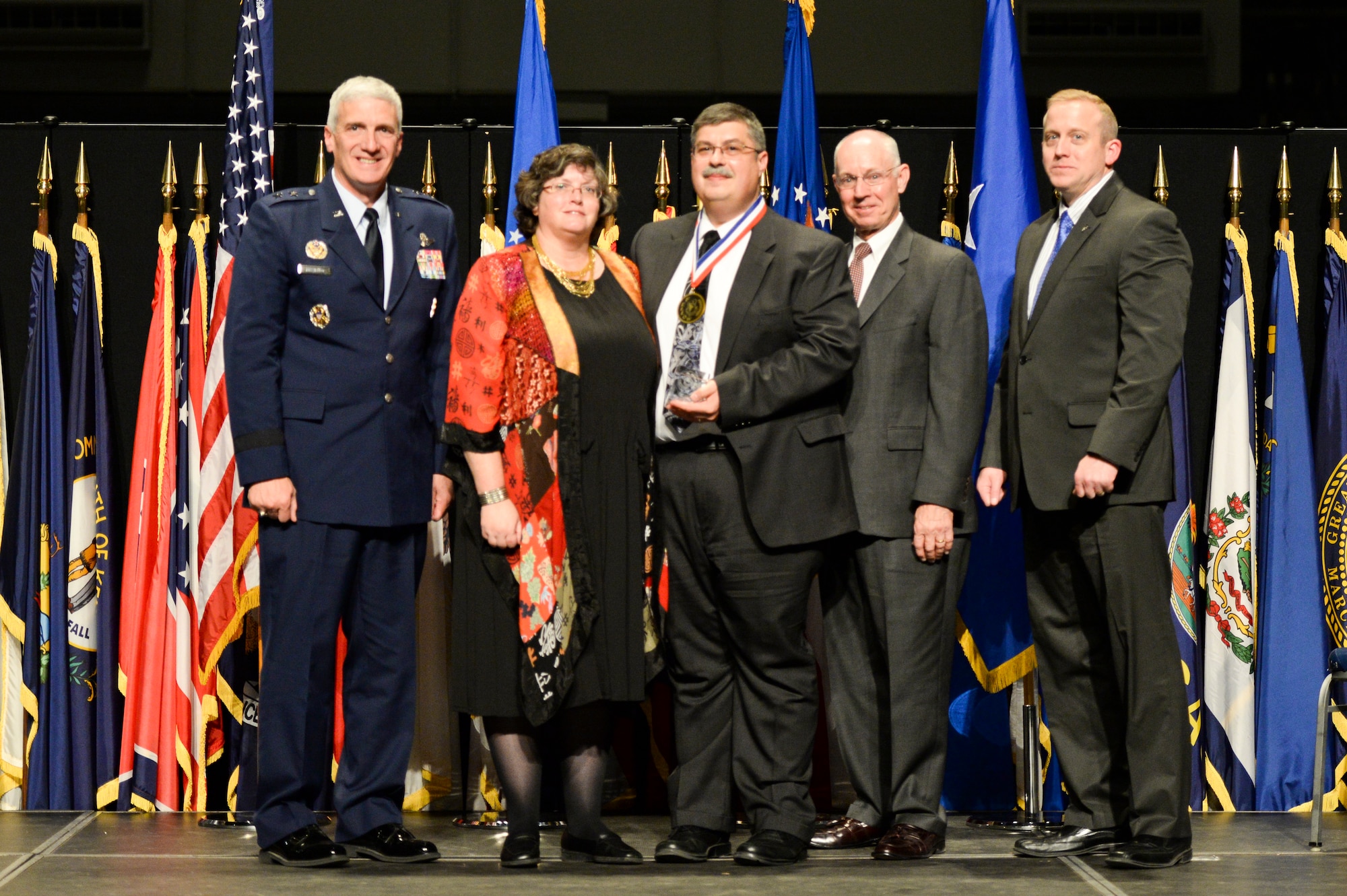 Dr. Charles Cross, chief, Turbine Engine Division, Air Force Research Laboratory Aerospace Systems Directorate, and his wife Kerrie, are honored during the 2014 AFRL Fellows and Early Career Awards Banquet, Oct. 30 at the National Museum of the U.S. Air Force. Joining them are Maj. Gen Tom Masiello, AFRL commander, Maj. Gen. Dick Paul, AFRL's first commander, and Dr. Morley Stone, AFRL chief technology officer.  (U.S. Air Force photo/Wesley Farnsworth)
