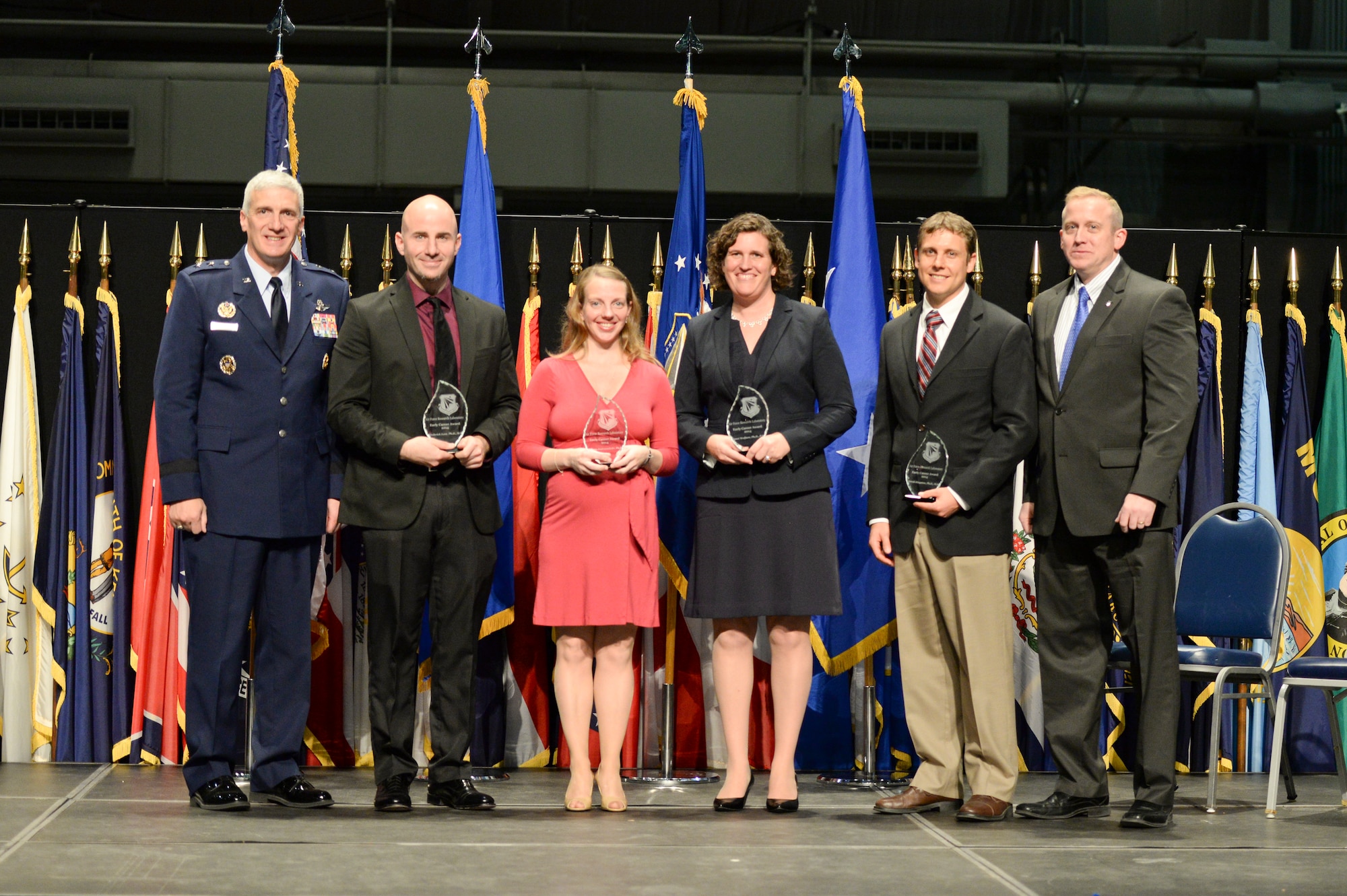 Maj. Gen. Tom Masiello and Dr. Morley Stone (far right) presented four Air Force Research Laboratory Early Career Awards Oct. 30, 2014 at the National Museum of the U.S. Air Force. The award recognizes AFRL's most outstanding young scientists and engineers for scientific or engineering work early in their careers. From left: Dr. Frederick Leve, Research Aerospace Engineer, Space Vehicles Directorate; Dr. Tiffany Jastrzembski, cognitive research scientist, 711th Human Performance Wing; Dr. Janet Wolfson, senior mechanical engineer, Munitions Directorate; and Dr. Derek Kingston, Unmanned Aerial Vehicle team lead, Control Science Center of Excellence, Aerospace Systems Directorate.
Maj. Gen. Masiello is AFRL commander, and Dr. Stone, AFRL chief technology officer. (U.S. Air Force photo/Wesley Farnsworth)