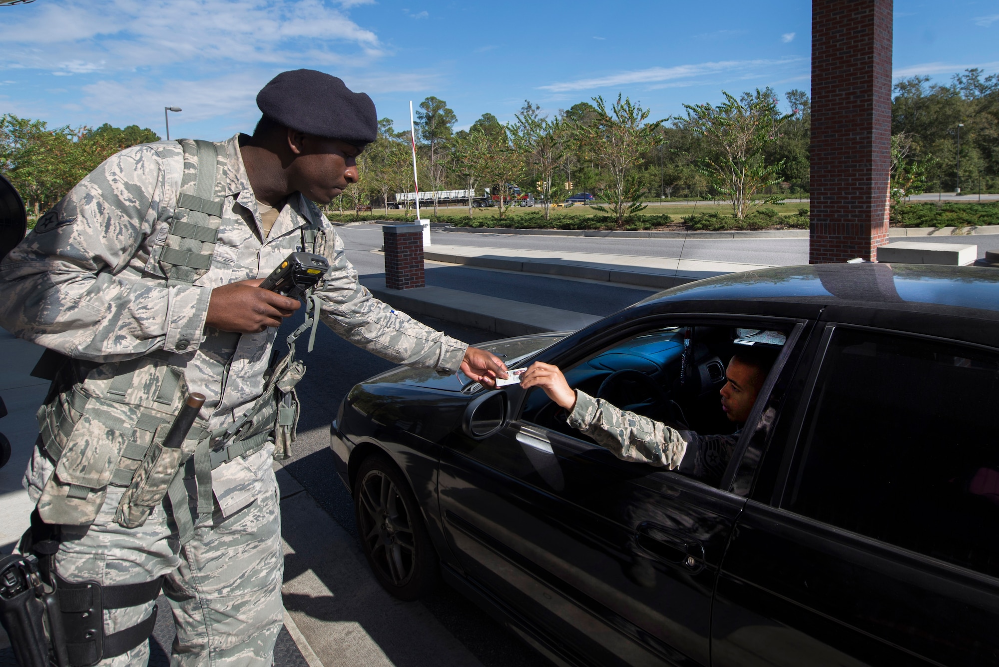 U.S. Air Force Airman Ronshad Bell, 23d Security Forces security guard, checks a driver’s Common Access Card for identification Oct. 29, 2014, at Moody Air Force Base, Ga. The 23d SFS introduced the Defender’s Edge program to strength resiliency in all of their duties, including manning the gates. (U.S. Air Force photo by Airman 1st Class Dillian Bamman/Released)