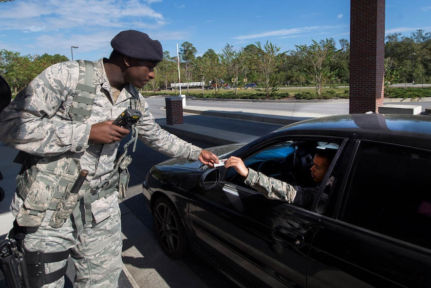 U.S. Air Force Airman Ronshad Bell, 23d Security Forces security guard, checks a driver’s Common Access Card for identification Oct. 29, 2014, at Moody Air Force Base, Ga. The 23d SFS introduced the Defender’s Edge program to strength resiliency in all of their duties, including manning the gates. (U.S. Air Force photo by Airman 1st Class Dillian Bamman/Released)