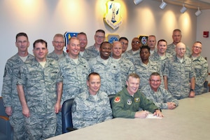 The 127th Wing Chiefs Council surround Col. Philip Sheridan, 127th Wing commander, as he signs the approval for Building 409 to be used as the Enlisted Heritage House at Selfridge Air National Guard Base on October 31, 2014.  The facility will be used for enlisted council meetings and host a heritage room, featuring photos and other information about the contributions of Michigan Air National Guard enlisted Airmen. (U.S. Air National Guard photo by Tech. Sgt. Dan Heaton)