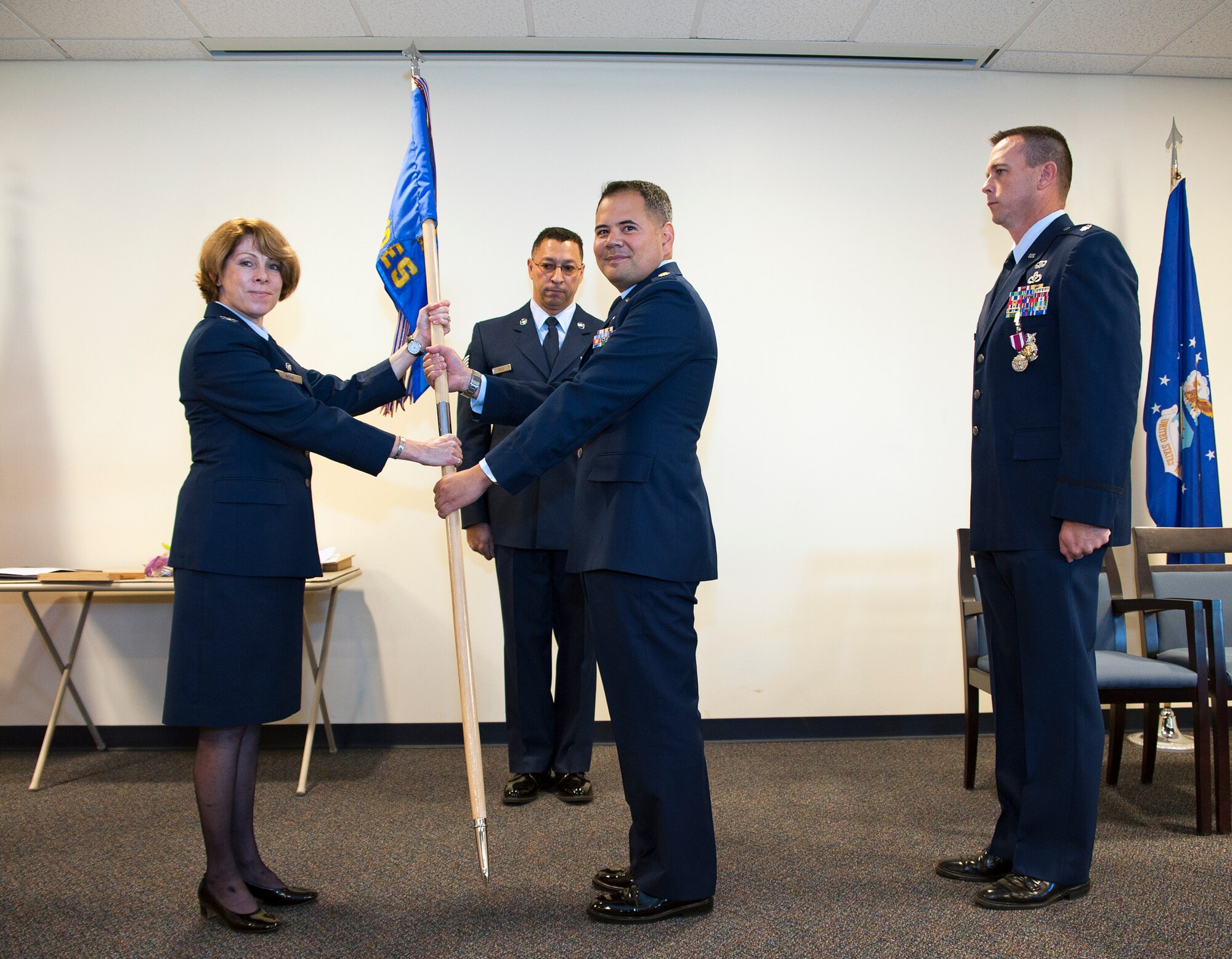 Col. Cynthia Wong, 514th Mission Support Group commander, passes the 514th Civil Engineer Squadron's guidon to the squadrons new commander Lt. Col. James Tehero during a Change of Command ceremony here October 25 (US Air Force/Christian DeLuca).