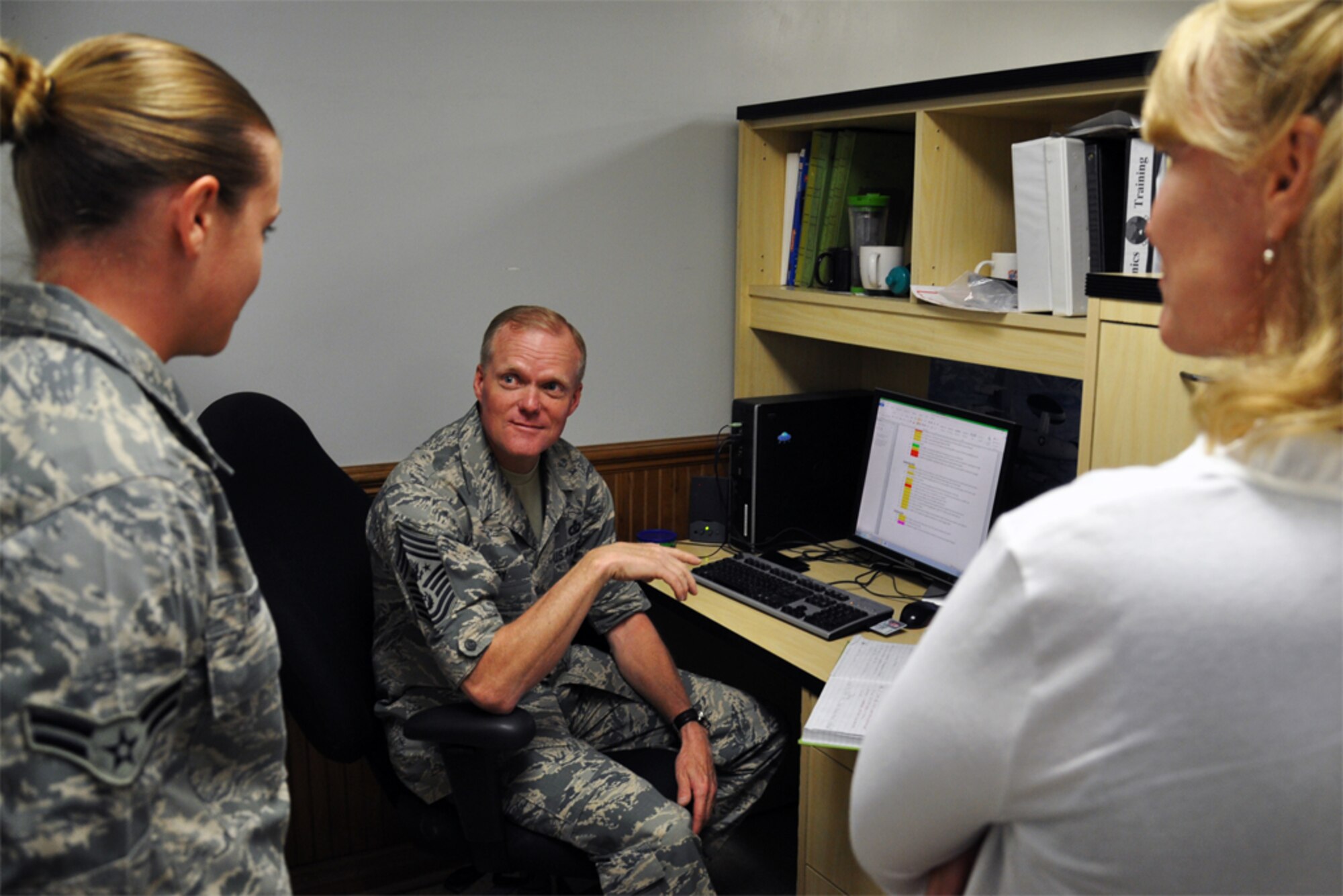 Chief Master Sgt. of the Air Force James Cody and his wife, retired Chief Master Sgt. Athena Cody, speak with Airman 1st Class Savana Hopkins, 911th Air Refueling Squadron, integrated flight controls specialist, while visiting Seymour Johnson Air Force Base, North Carolina, Oct. 10. Hopkins was among several Airmen Cody recognized for excellent service to the 916th ARW. (U.S. Air Force photo/Staff Sgt. Alan Abernethy)