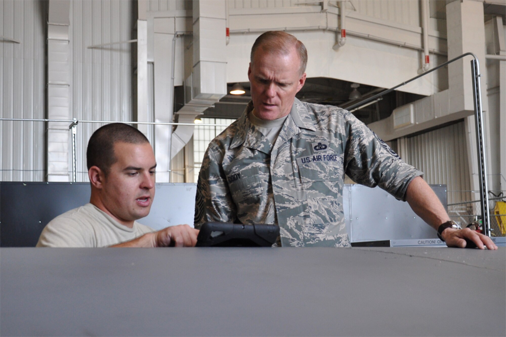 Chief Master Sgt. of the Air Force James Cody speaks with Senior Airman Geoffrey Rodgers, 916th Maintenance Squadron, about his maintenance repair tasks while visiting Seymour Johnson Air Force Base, North Carolina, Oct. 10. During the visit, Cody spent time with Airmen of the 916th ARW and its Total Force Associate partner, the 911th Air Refueling Squadron. (U.S. Air Force photo/Staff Sgt. Alan Abernethy)