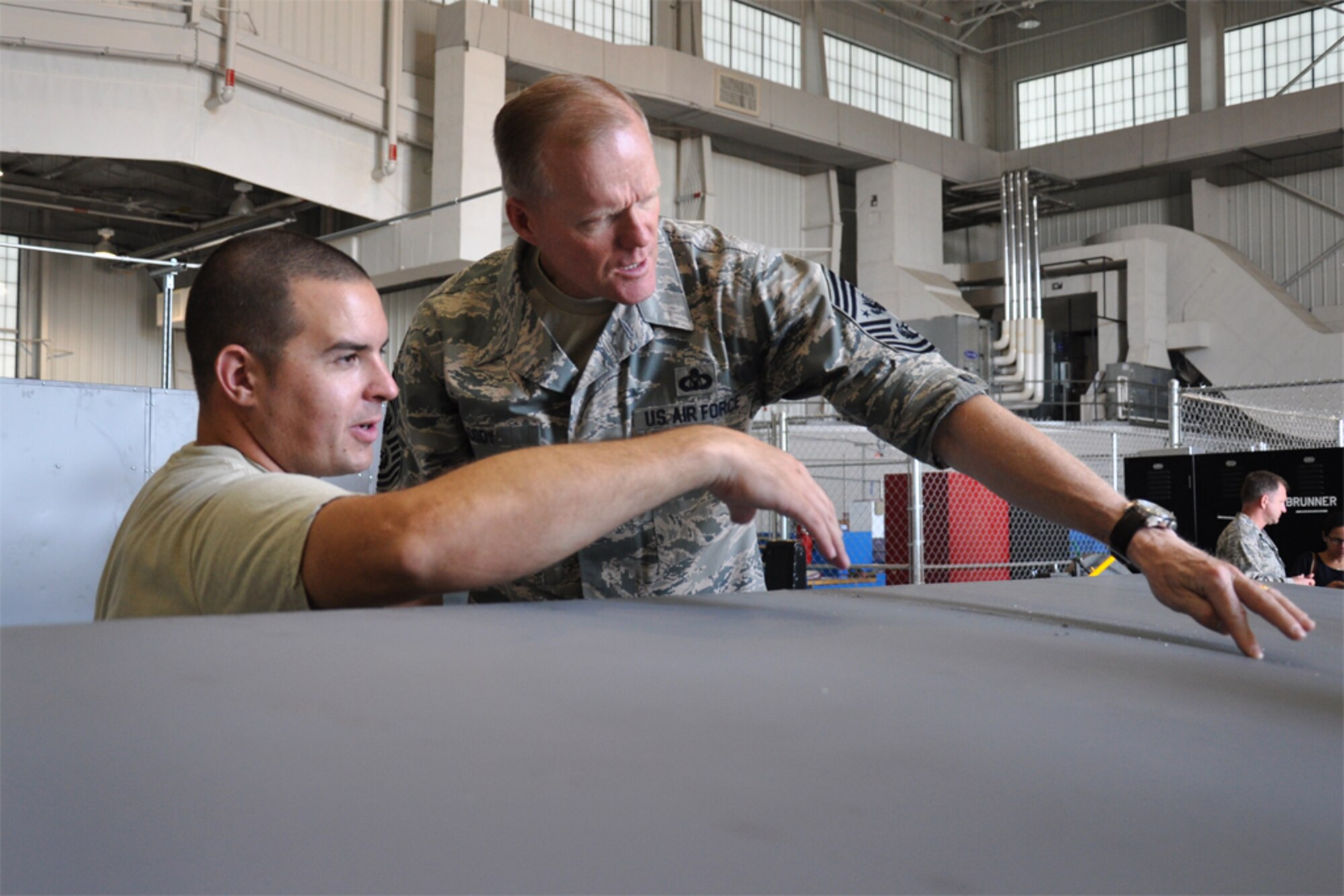 Chief Master Sgt. of the Air Force James Cody speaks with Senior Airman Geoffrey Rodgers, 916th Maintenance Squadron, about his maintenance repair tasks while visiting Seymour Johnson Air Force Base, North Carolina, Oct. 10. During the visit, Cody spent time with Airmen of the 916th ARW and its Total Force Associate partner, the 911th Air Refueling Squadron. (U.S. Air Force photo/Staff Sgt. Alan Abernethy)