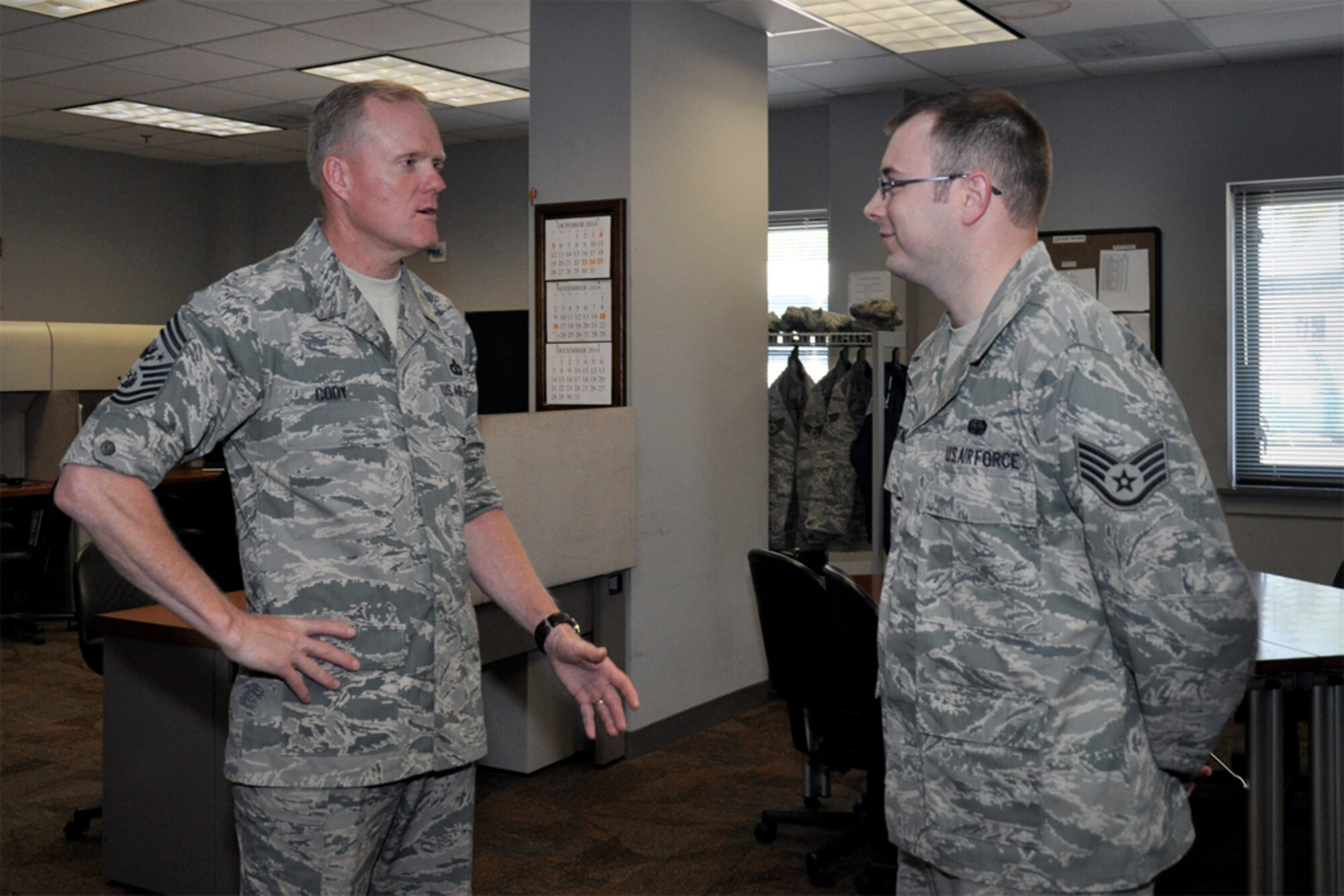 Chief Master Sgt. of the Air Force James Cody speaks with Staff Sgt. Paul Houghtaling, 916th Maintenance Squadron, knowledge operations manager, while visiting Seymour Johnson Air Force Base, North Carolina, Oct. 10. Houghtaling was among several Airmen that Cody recognized for excellent service to the 916th ARW. (U.S. Air Force photo/Staff Sgt. Alan Abernethy)