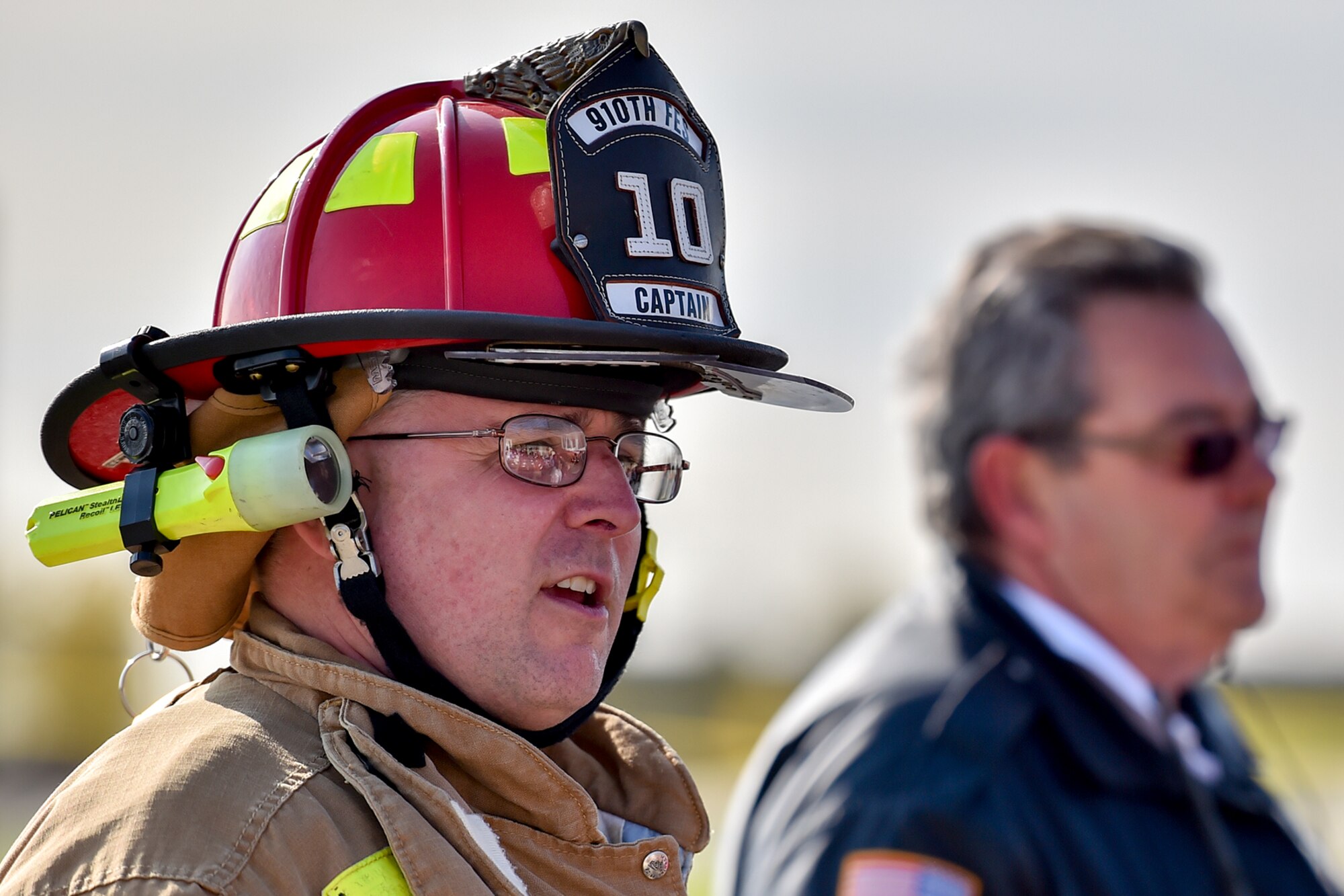 YOUNGSTOWN AIR RESERVE STATION, Ohio -- 910th Airlift Wing Civil Engineer Fire Department Captain Kevin Brichetto addresses a crowd of invited guests and media representatives after a capabilities demonstration by the base fire department here, Oct. 27, as part of an emergency response capabilities demonstration during the American Red Cross’ Feel the Heat event. An audience of invited guests and area media representatives observed the exercise, which showcased the partnership between the military and the Red Cross as the second event to take place as part of the Air Force Community Partnership Program here, which has been ongoing since June 23, 2014. U.S. Air Force photo by Mr. Eric M. White