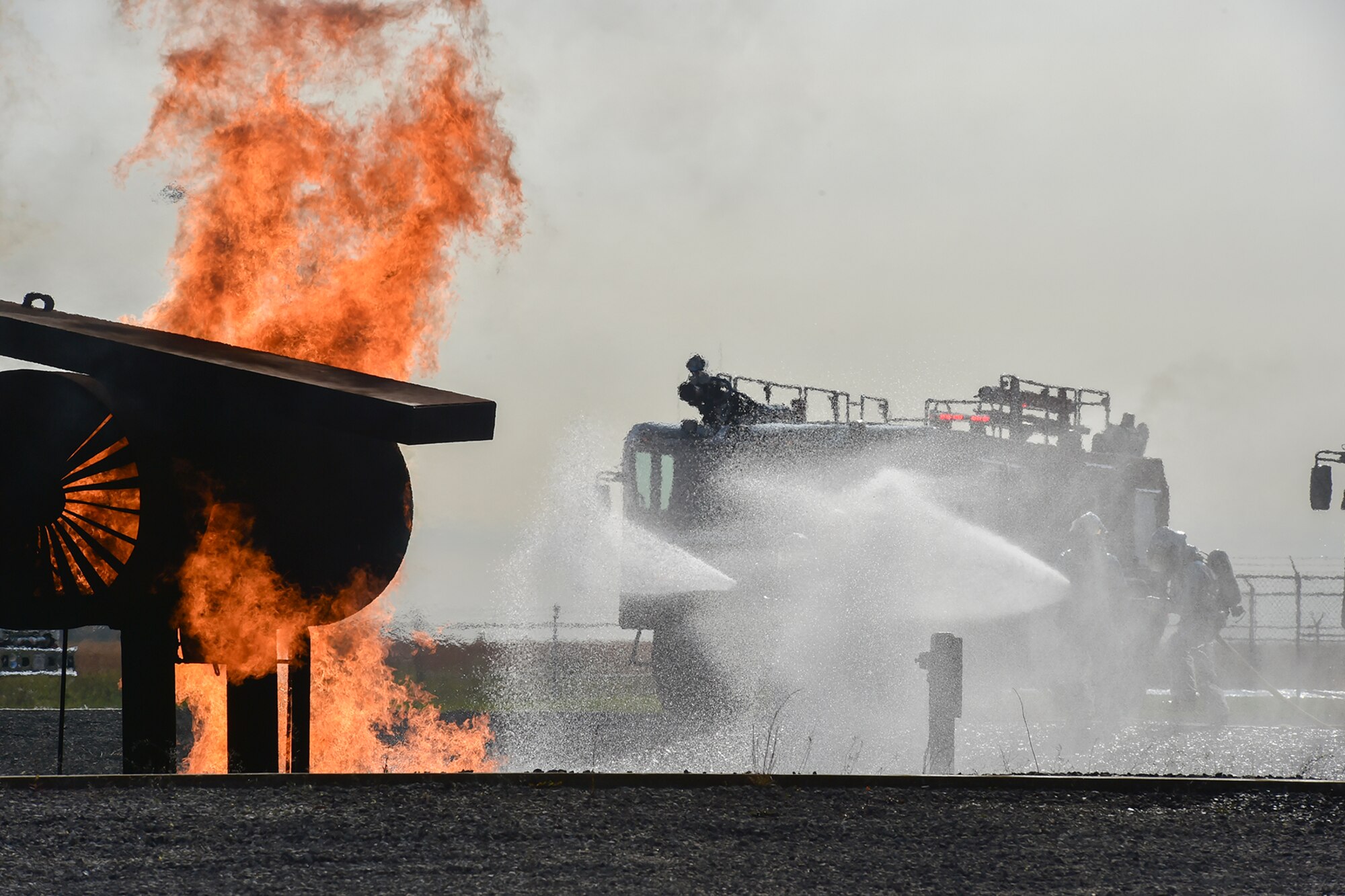 YOUNGSTOWN AIR RESERVE STATION, Ohio -- Firefighters from the 910th Airlift Wing Civil Engineer Fire Department fight a controlled fire on a mock aircraft here, Oct. 27, as part of an emergency response capabilities demonstration during the American Red Cross’ Feel the Heat event. An audience of invited guests and area media representatives observed the exercise. The exercise showcased the partnership between the military and the Red Cross as the second event to take place as part of the Air Force Community Partnership Program here, which has been ongoing since June 23, 2014. U.S. Air Force photo by Mr. Eric M. White