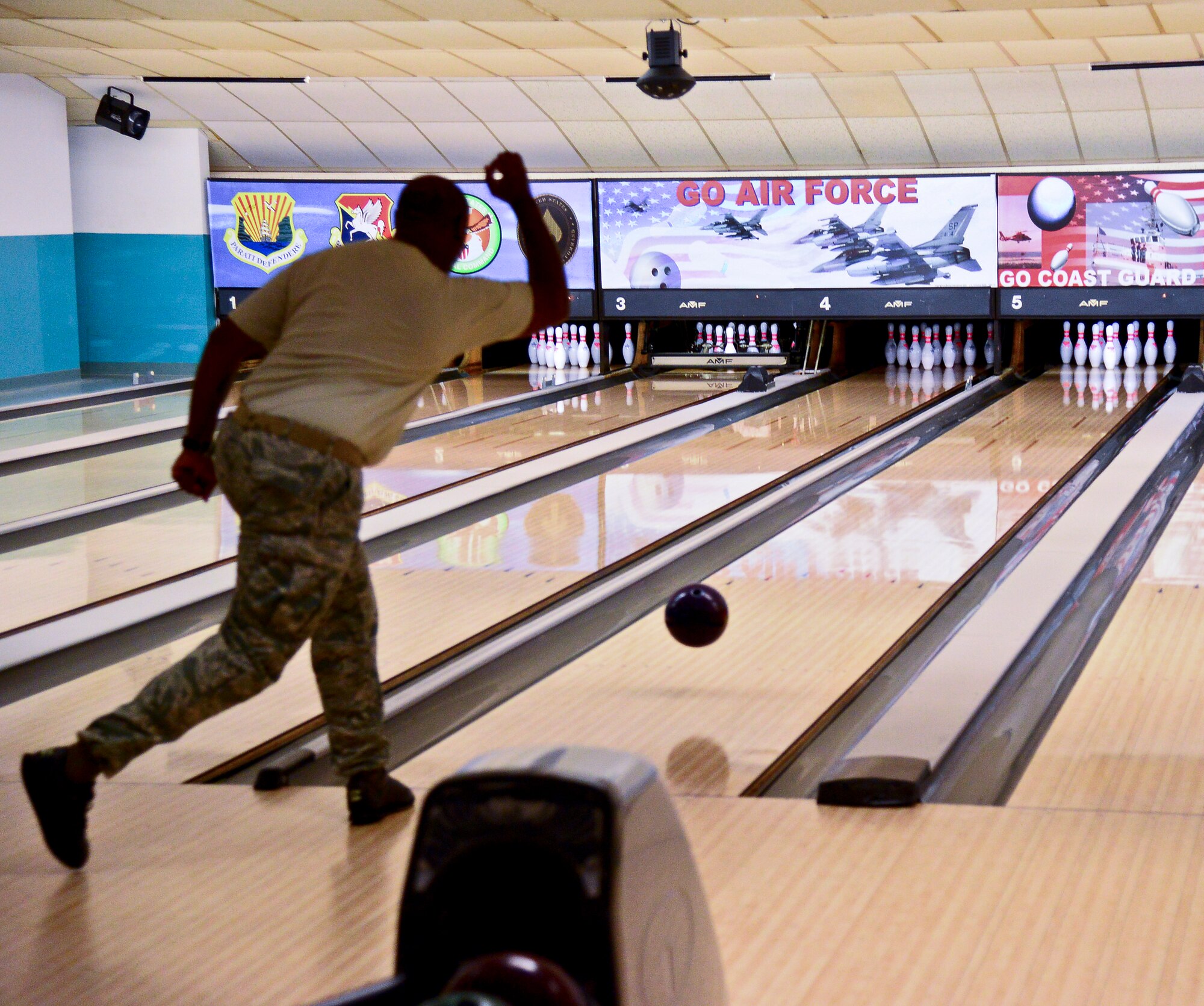 Master Sgt. Robert Smith, MacDill Area Resilience Center superintendent, bowls during the Strike- Out Domestic Violence bowling event at MacDill Air Force Base, Fla., Oct. 30, 2014. The goal of the event was to provide people a comfortable way to talk about the issue of domestic violence. (U.S. Air Force photo by Senior Airman Vernon L. Fowler Jr./Released)