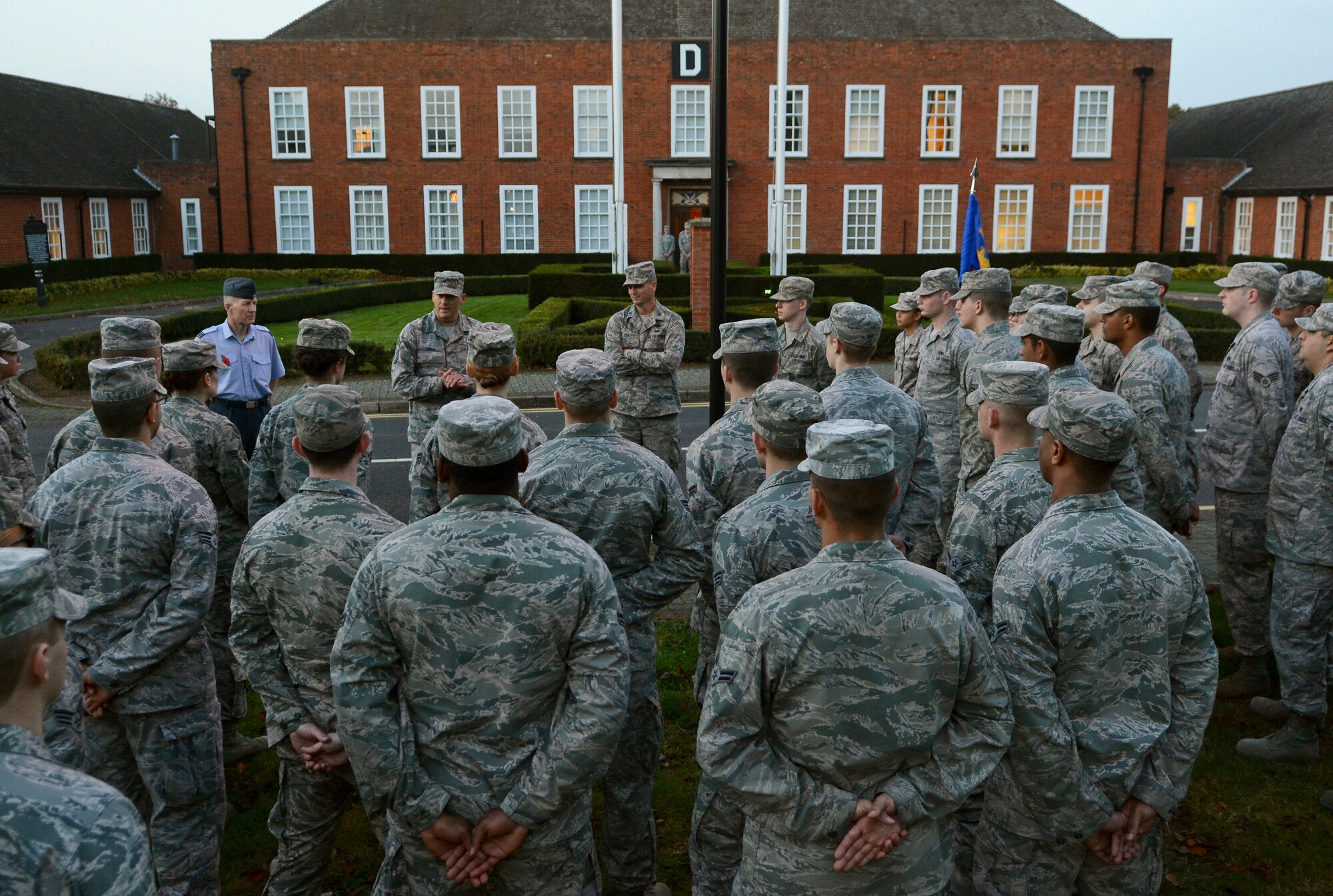 Team Mildenhall leadership address Airmen after a retreat ceremony Oct. 30, 2014, on RAF Mildenhall England. The Airmen Committed to Excellence council organized a formation comprised of only junior enlisted military members to mark the last retreat ceremony of the year. (U.S. Air Force photo by Staff Sgt. Micaiah Anthony/Released)