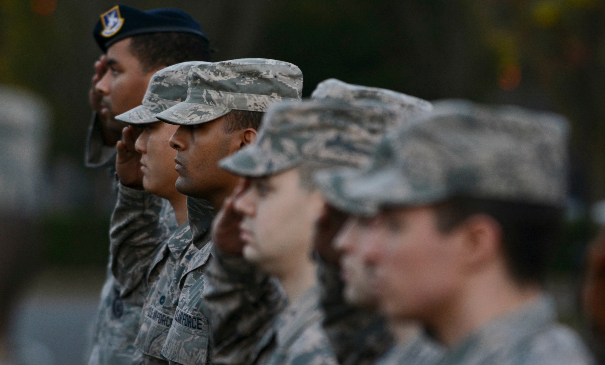 Team Mildenhall Airmen salute during a retreat ceremony Oct. 30, 2014, on RAF Mildenhall England. The Airmen Committed to Excellence council organized a formation comprised of only junior enlisted military members to mark the last retreat ceremony of the year. (U.S. Air Force photo by Staff Sgt. Micaiah Anthony/Released)