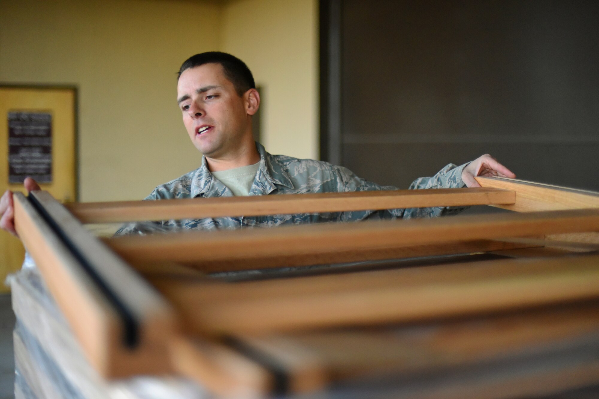 Tech. Sgt. Lee Olson, 341st Operations Group supply coordinator, inspects new bed frames before transporting them into the OG supply warehouse on Oct. 20 to be stored for distribution. The bed frames are just a few items purchased with more than $1 million worth of Force Improvement Program funds, being used to provide a better quality of life for Airmen. (U.S. Air Force photo/Airman 1st Class Collin Schmidt)