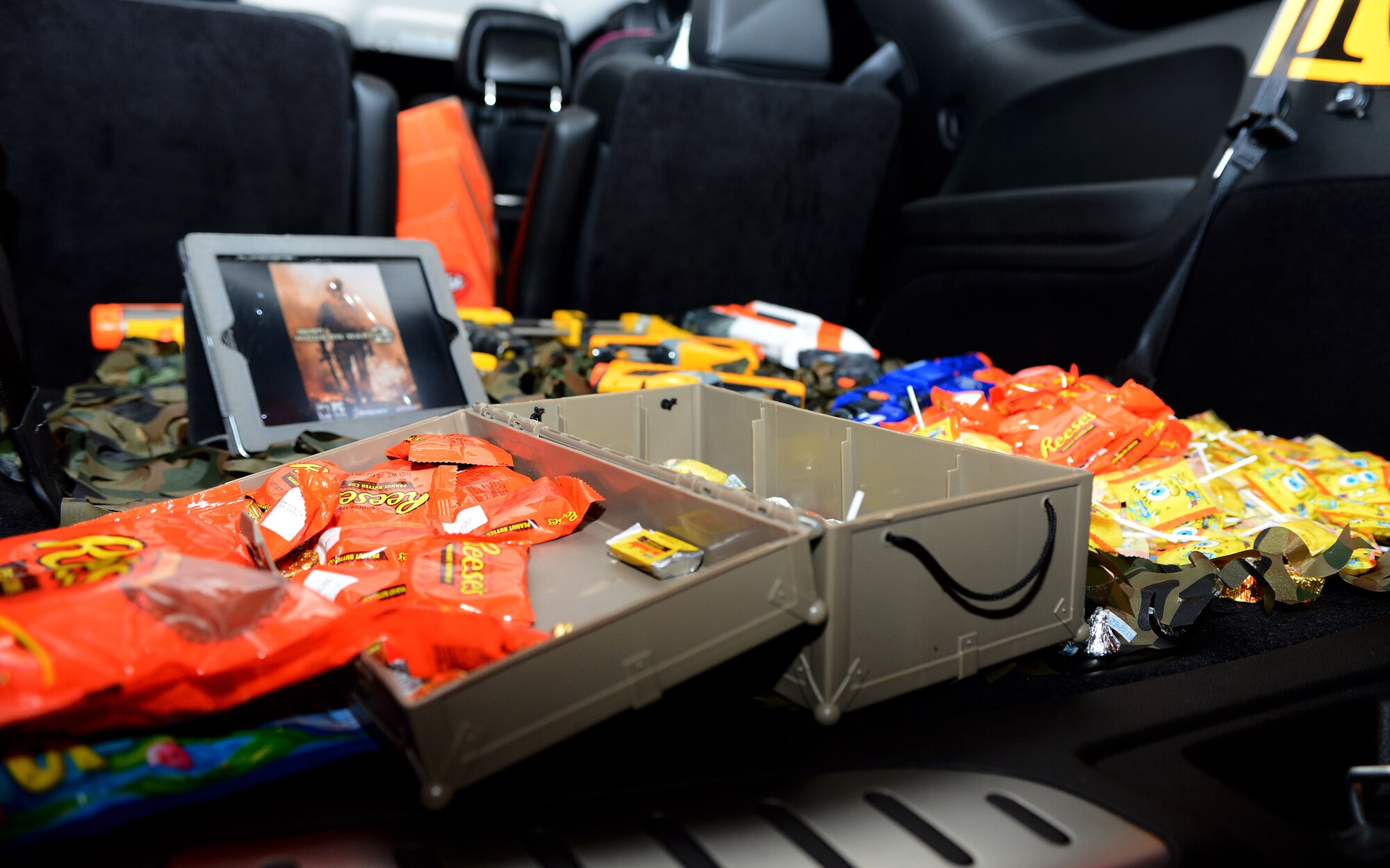 Assorted candy lies inside a car trunk for “Trunk-or-Treat” during Family Fright Night at the Club Eifel parking lot on Spangdahlem Air Base, Germany, Oct. 30, 2014. More than 10 vehicles and 50 volunteers participated in the “Trunk-or-Treat” event. (U.S. Air Force photo by Airman 1st Class Luke Kitterman/Released)