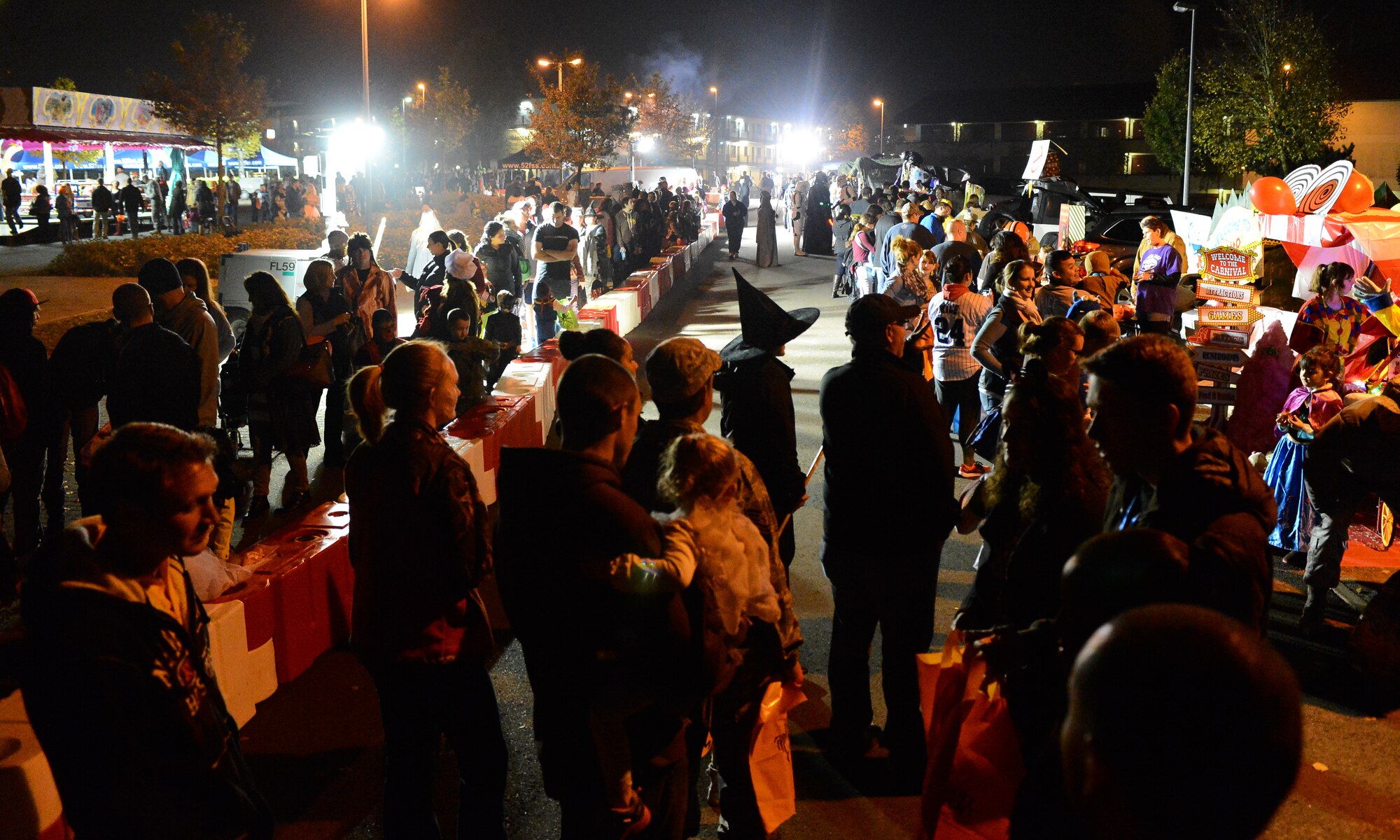 Trick-or-treaters and their family members wait in line to go through the “Trunk-or-Treat” event during Family Fright Night at the Club Eifel parking lot on Spangdahlem Air Base, Germany, Oct. 30, 2014. More than 400 members of the Spangdahlem community attended. (U.S. Air Force photo by Airman 1st Class Luke Kitterman/Released)