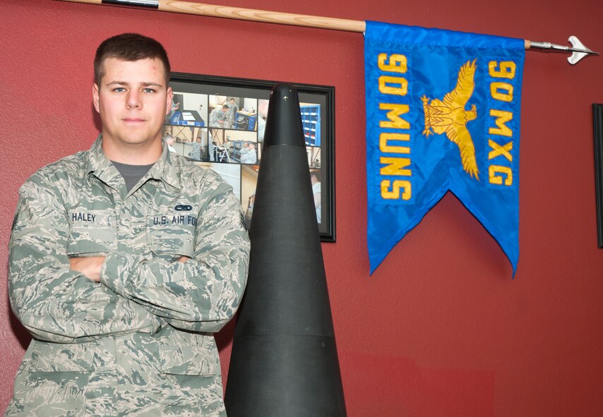Senior Airman Dylan Haley, 90th Munitions Squadron team chief, poses for a photo Oct. 31, 2014, in the 90th MUNS squadron building. Haley was awarded the  2013 Air Force Nuclear Deterrence Operations Airman of the Year and coined by the Air Force Global Strike Command inspector general. (Air Force photo by Airman Malcolm Mayfield)

