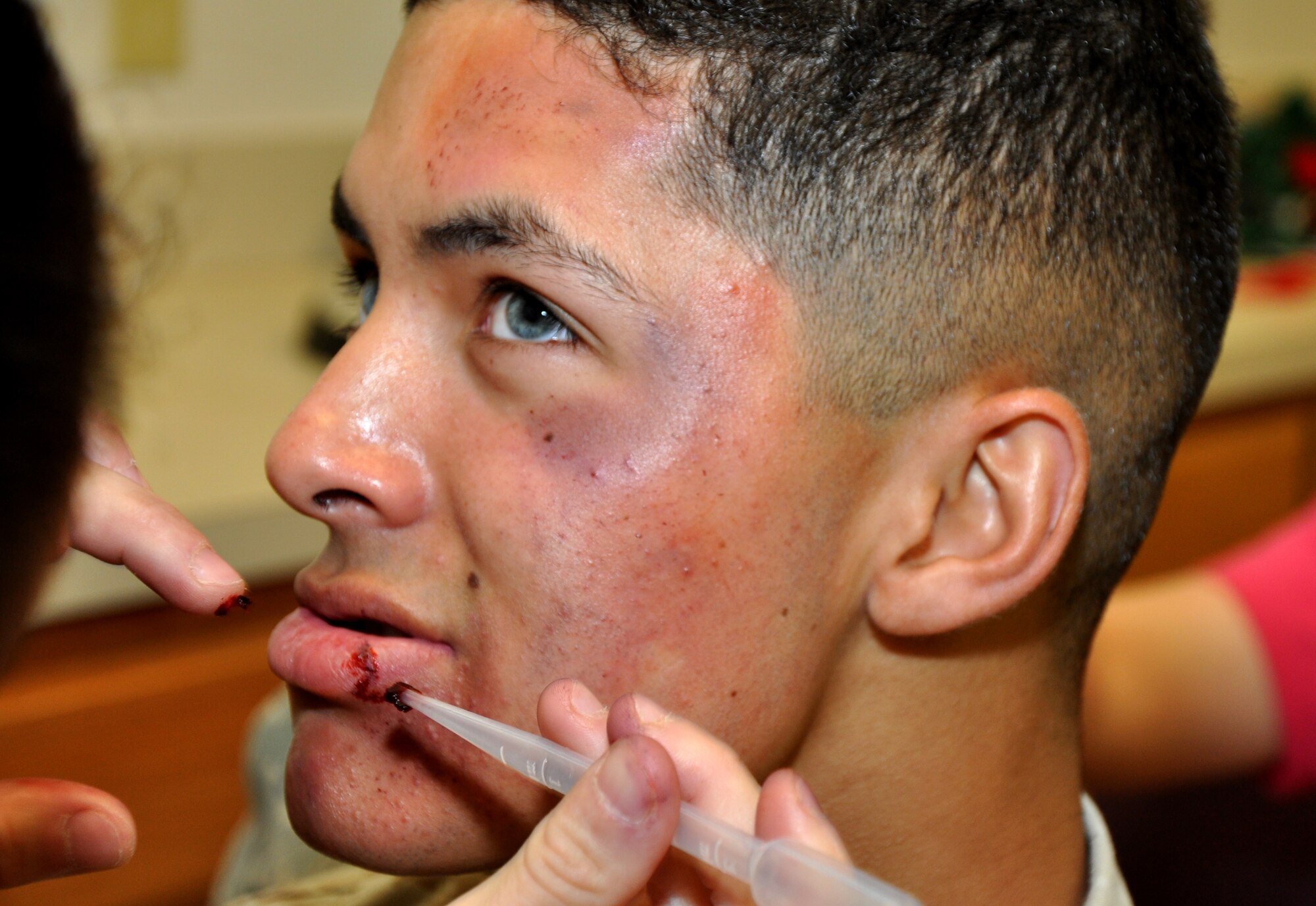 GOODFELLOW AIR FORCE BASE, Texas – Marine Corps Pfc. Ben F. Morales, Marine Corps Detachment student and 17th Security Forces Squadron entry controller, receives makeup for the Black Eye Campaign at the Mathis Fitness Center Oct. 30. During the Black Eye Campaign, Morales and other volunteers played domestic violence victims to raise awareness about the resources victims have on base. The Family Advocacy-sponsored event also tested how individuals reacted to a victim’s injuries. (U.S. Air Force photo/ Senior Airman Joshua Edwards)