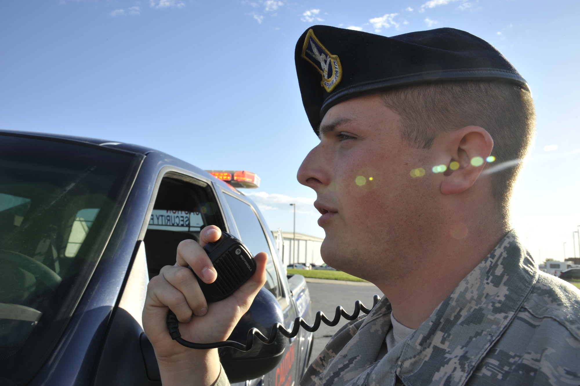 U.S. Air Force Senior Airman Matthew Hinson, 509th Security Forces Squadron patrolman, talks on a whisper mic at Whiteman Air Force Base, Mo., Oct. 8, 2014. The whisper mic is used to relay information to the police services desk during responses to unannounced building alarms.  (U.S. Air Force photo by Airman 1st Class Keenan Berry/Released)