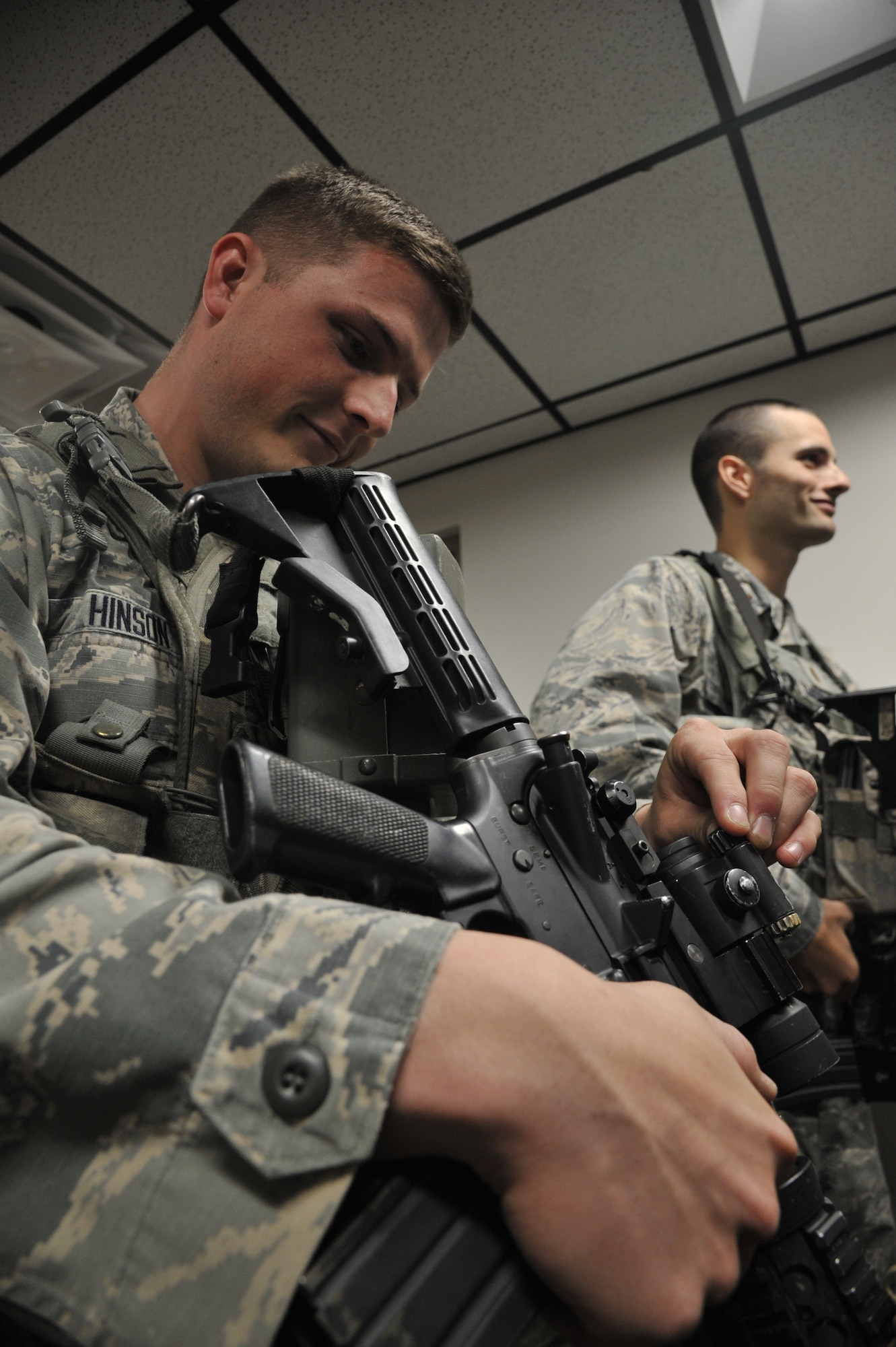 U.S. Air Force Senior Airman Matthew Hinson, 509th Security Forces Squadron patrolman, checks the status of his issued equipment at Whiteman Air Force Base, Mo., Oct. 8, 2014. This procedure is done to ensure there are no defects and the equipment is functioning properly. (U.S. Air Force photo by Airman 1st Class Keenan Berry/Released)