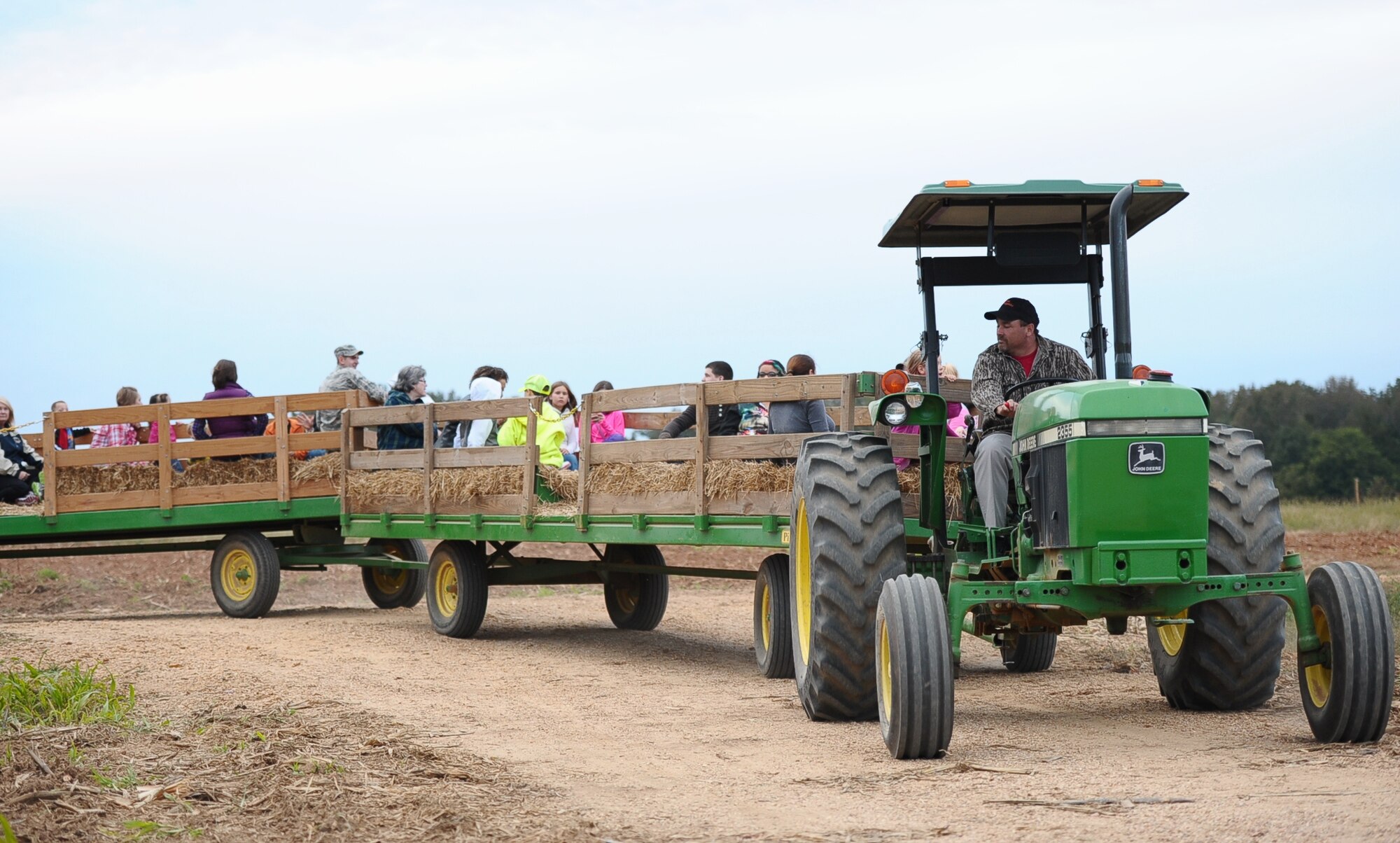 Brian Labonte, Country Pumpkins Harvest-master, drives Hearts Apart attendees on a hay-ride during their visit at Country Pumpkins in Caledonia, Mississippi, Oct. 23. Hearts Apart is run by the Airman and Family Readiness Center for spouses and families of deployed military personnel. (U.S. Air Force photo/ Airman Daniel Lile)
